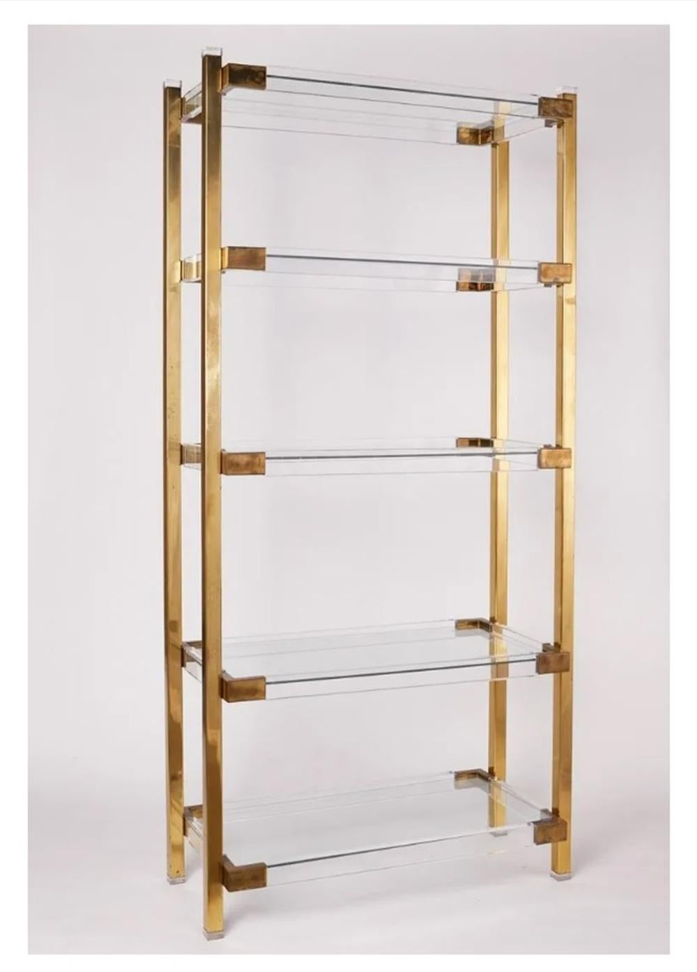 USA 1960's.

Introducing the Lucite & Brass Etagere with Five Shelves by Charles Hollis Jones, the perfect addition to your modern home décor. 

This stunning brass and glass shelf features five shelves made of clear acrylic, providing a sleek and
