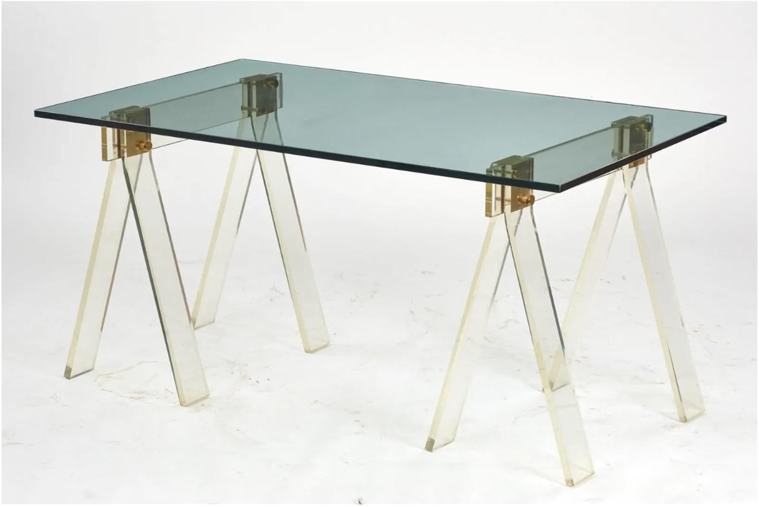 Beautiful dining table or desk made in solid Lucite, brass and a glass top.

The legs are made in the sawhorse frame with brass hardware and a thick glass top.

The base can fit a larger glass.

Measurements:
60 inches wide x 35.50 inches