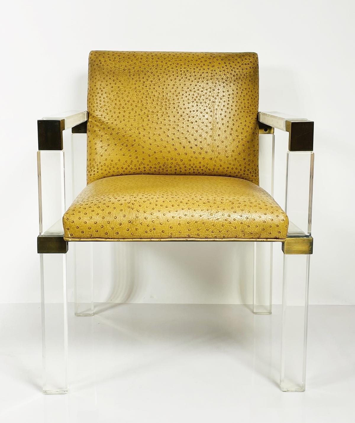 Introducing the Lucite & Brass Lounge Arm Chair by Charles Hollis Jones, a stunning piece of furniture that will elevate any space with its sleek and modern design. The chair features a unique combination of lucite and brass, creating a striking
