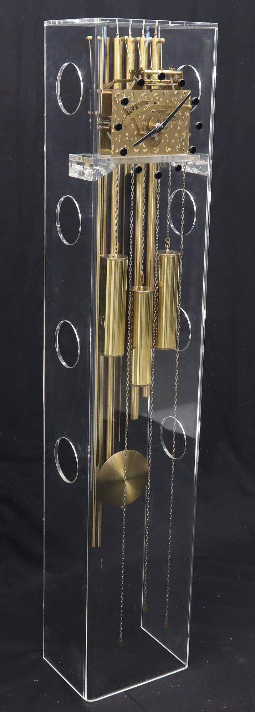 Mid-Century Modern Lucite and brass grandfather clock with deep chiming sound.