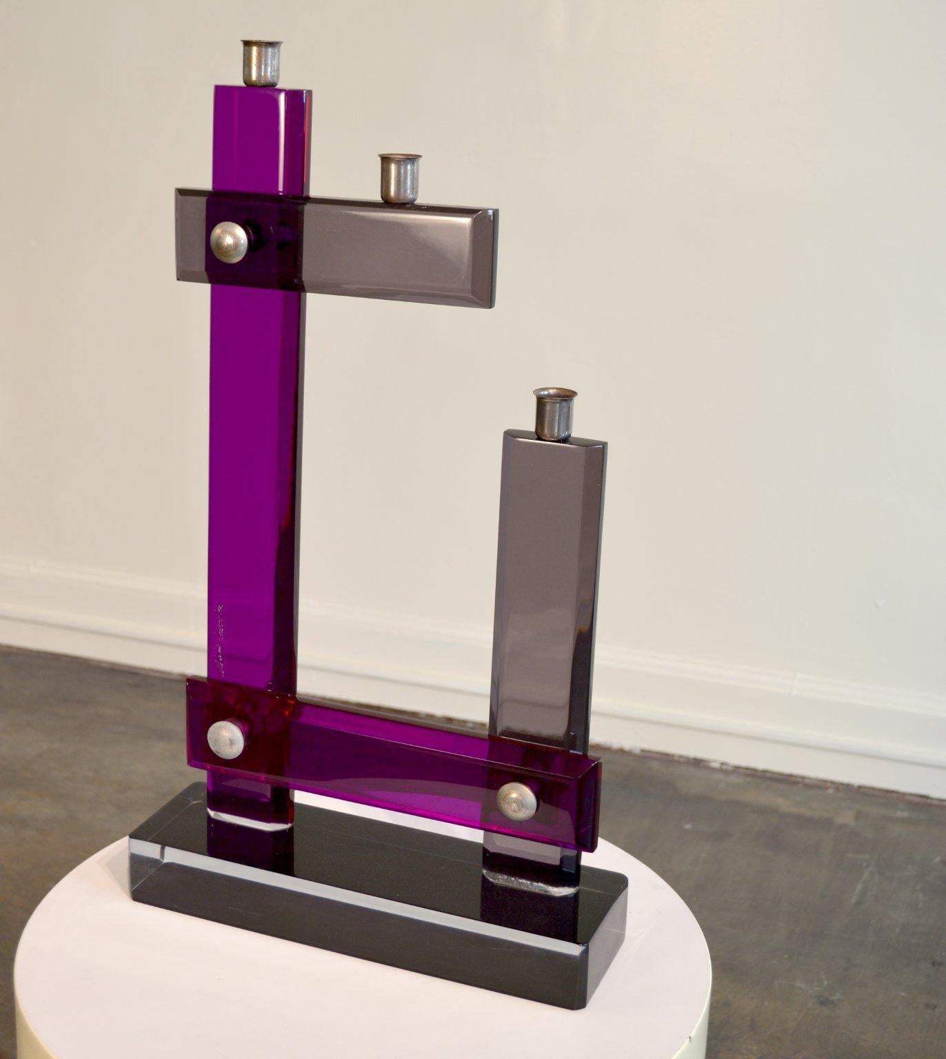 A striking 3-stick candelabra in colored Purple, Gray, Black, and Clear Lucite.  The piece is signed, 