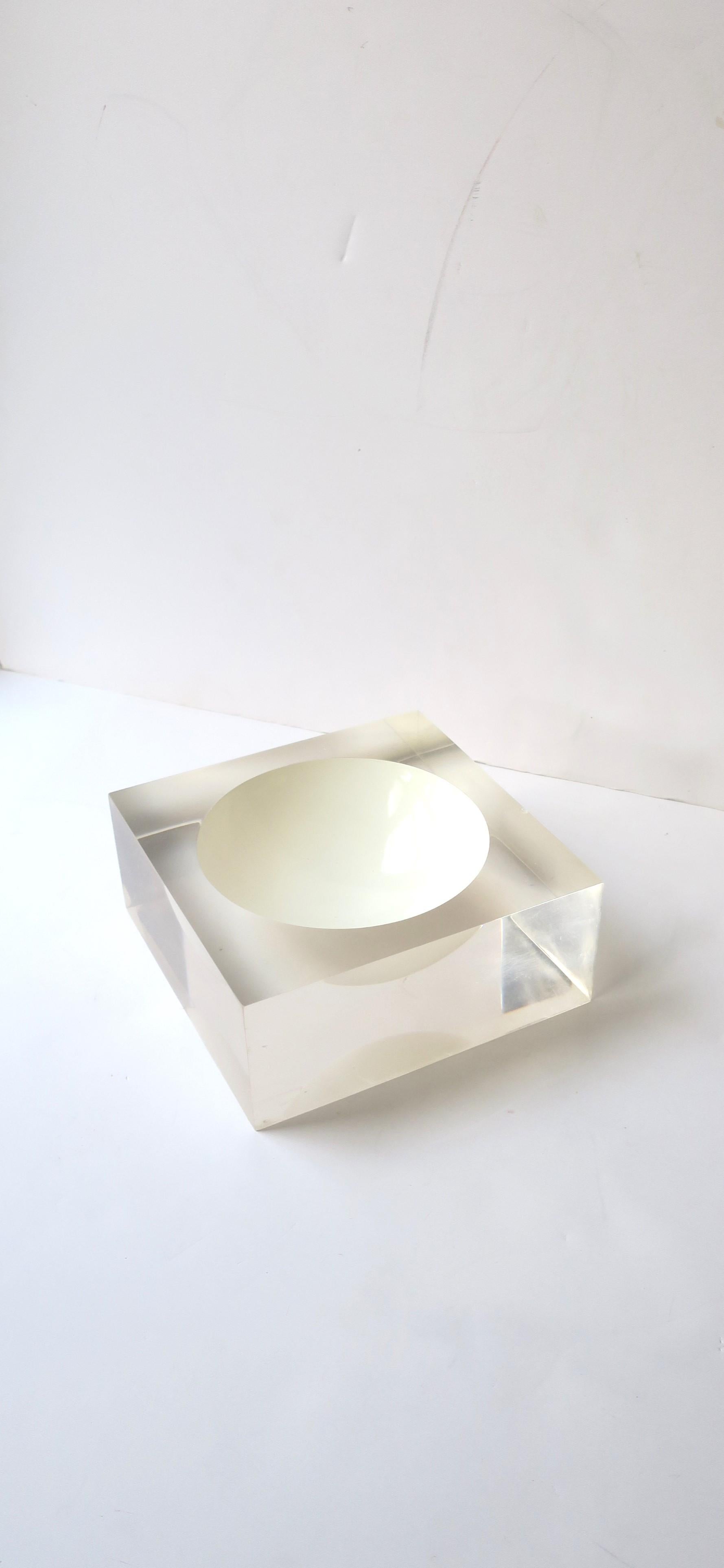 A substantial square Lucite vessel, bowl, or vide-poche (catchall) with white enamel center, in the modern style or Postmodern period, circa late-20th century. Great as a standalone piece, candy dish, or its intended use - a catchall for keys, coin