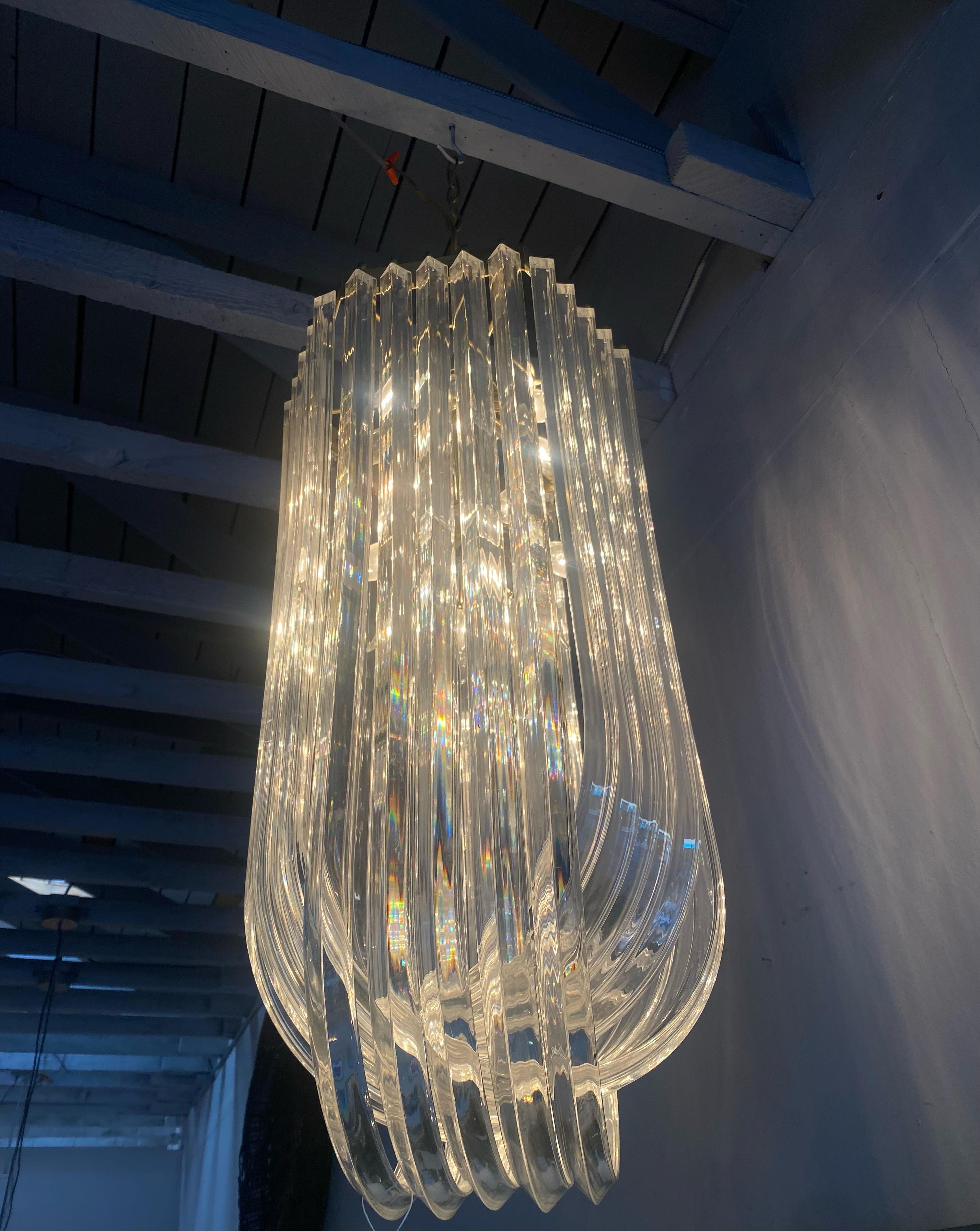 Stunning chandelier made from three tiers of overlapping lucite.