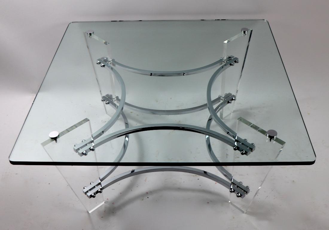 Slick, chic, and glamorous coffee table in Lucite, chrome, and glass by Charles Hollis Jones. This example is in very good, original condition, clean and ready to use.
Original plate glass top .50 in thick, shows a couple of minor scratches to