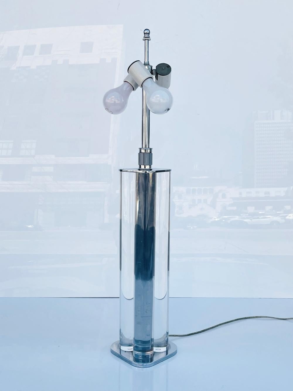 Beautiful table lamp with a chrome base and thick lucite rods in the style of Karl Springer.

The lamp takes 3 light bulbs, is it retains the original wiring.A true Mid Century modern statement piece.

Measurements:
30.50 inches high x 5.50