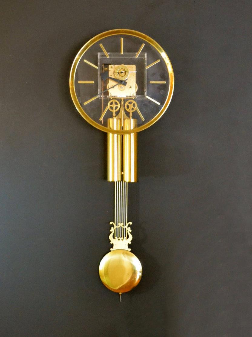 A wall hanging pendulum clock with a Lucite case by George Nelson for Howard Miller. Keeps good time and chimes on the hour and half hour. Movement made in Germany. Includes winding key.

As the pictures demonstrate, you can see the color of you
