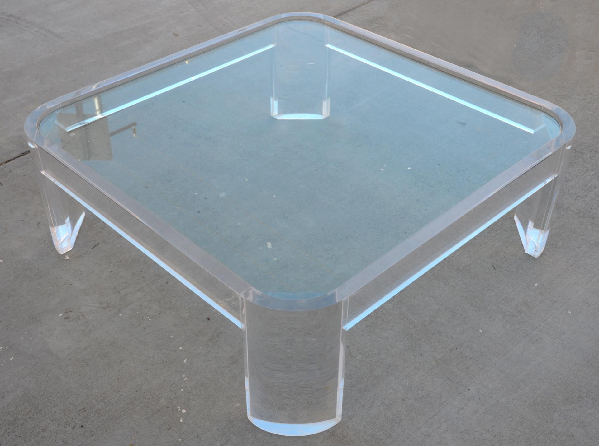 Square Lucite coffee table by Les Prismatiques with rounded corners and an inset glass top, sunk into the frame.

There is a small, subtle factory defect in the Lucite on one of the legs, just below the surface. This sort of defect is not uncommon