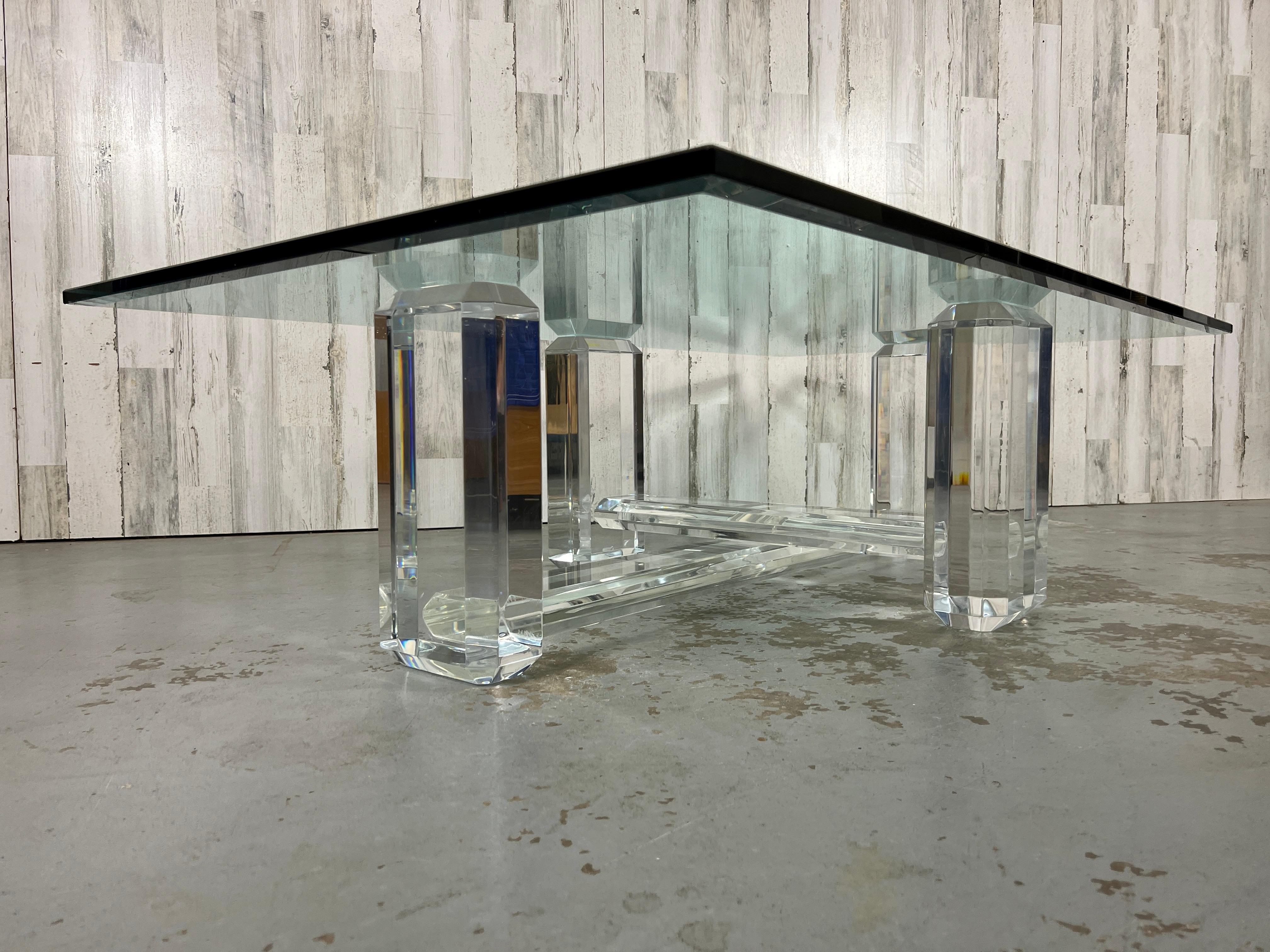 Beautiful Lucite legs with beveled edges and cross stretcher with beveled glass top. This lucite is thick and a high quality piece that will surely be a statement in anyones living space! 
