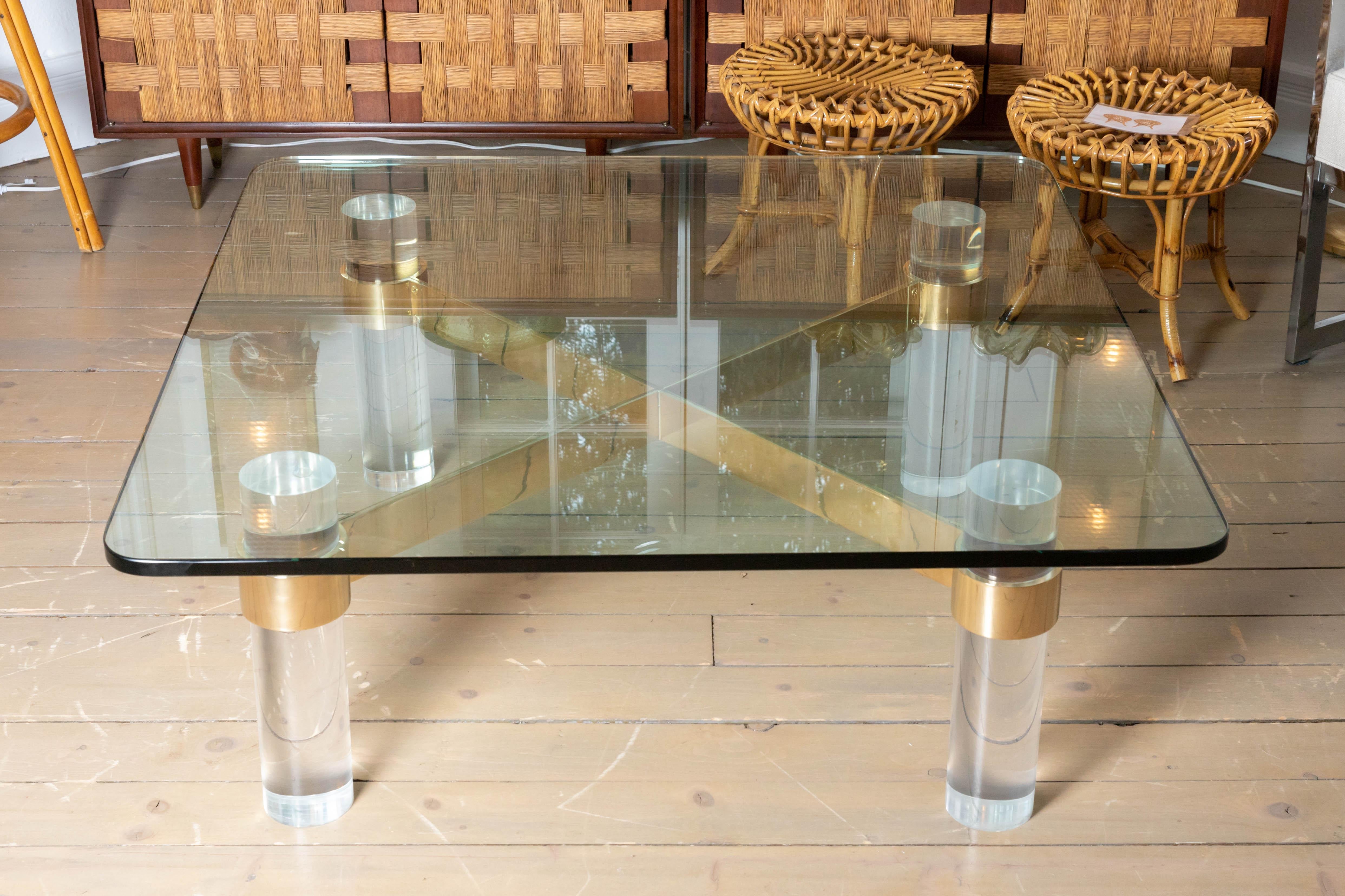 Coffee table with cylindrical Lucite element, cross bars and glass top, by Karl Springer.