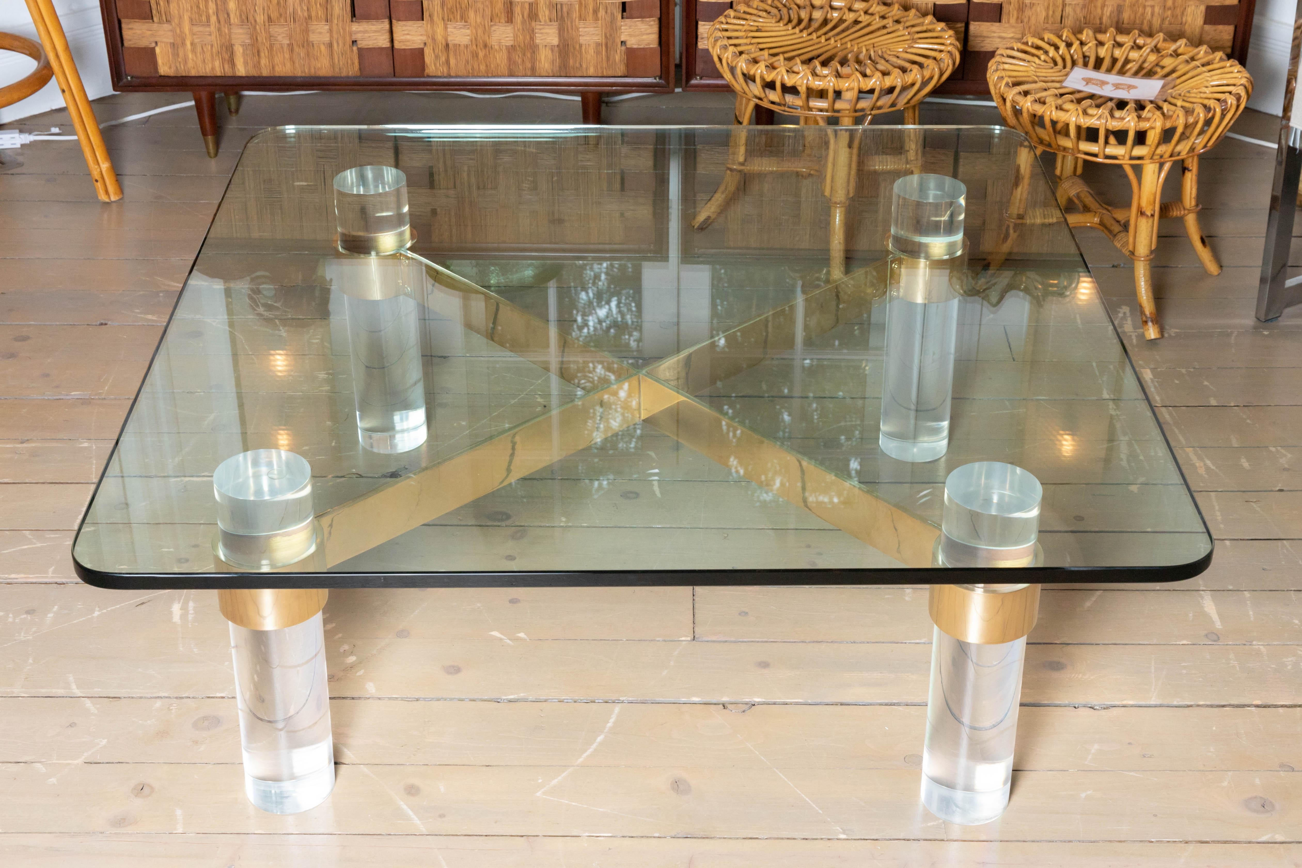 Lucite Colulmns, Brass Cross Bars Base and Glass Top Coffee Table, Karl Springer In Excellent Condition In Bridgehampton, NY