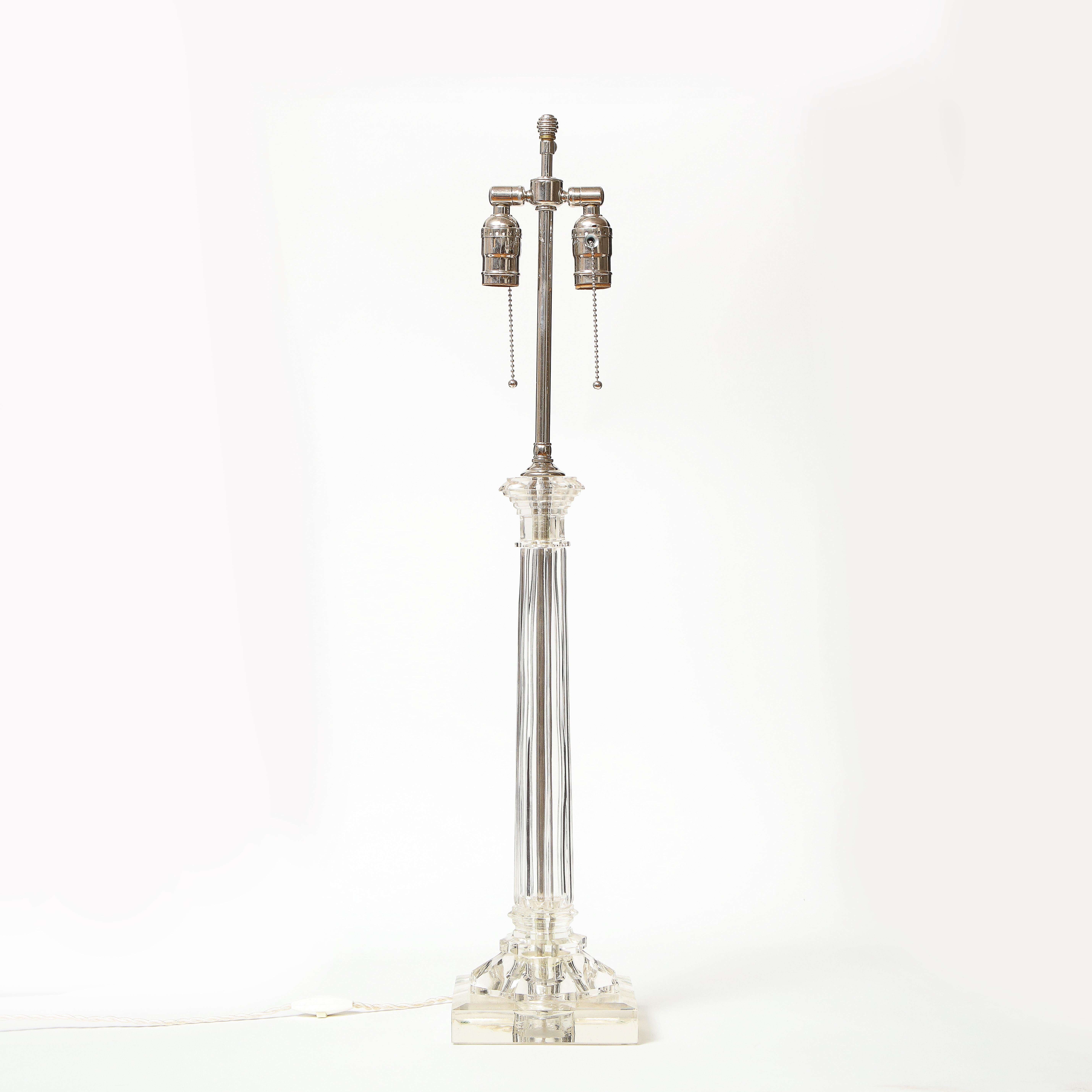 In the form of a Doric column; fitted in chrome with two bulb sockets and finial.
