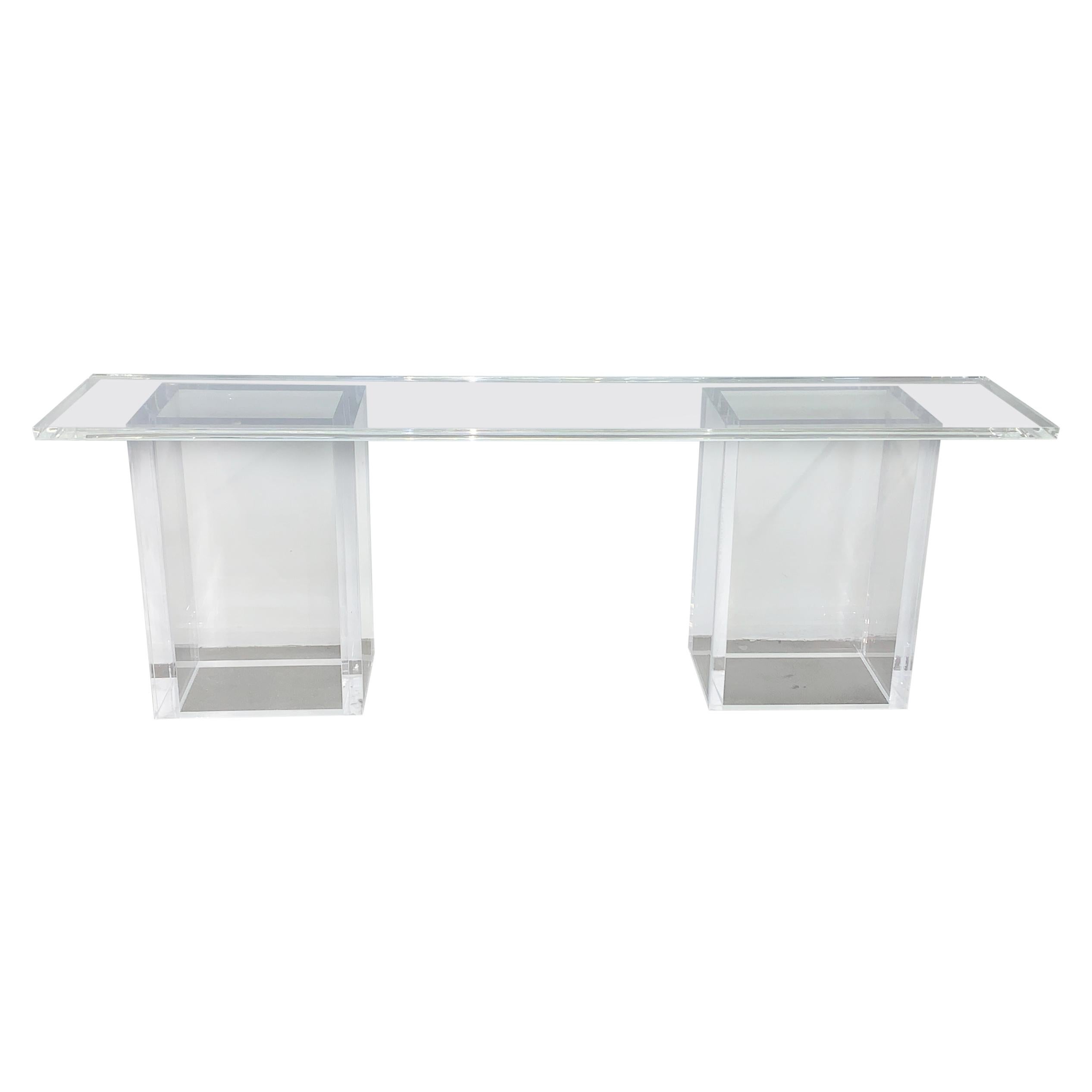A unique and large all Lucite console or sofa table. The top has a rabbit edge under the top and the bases are solid and heavy. The top sits on the movable bases and this can be configured in different ways. There are some scratches to the Lucite