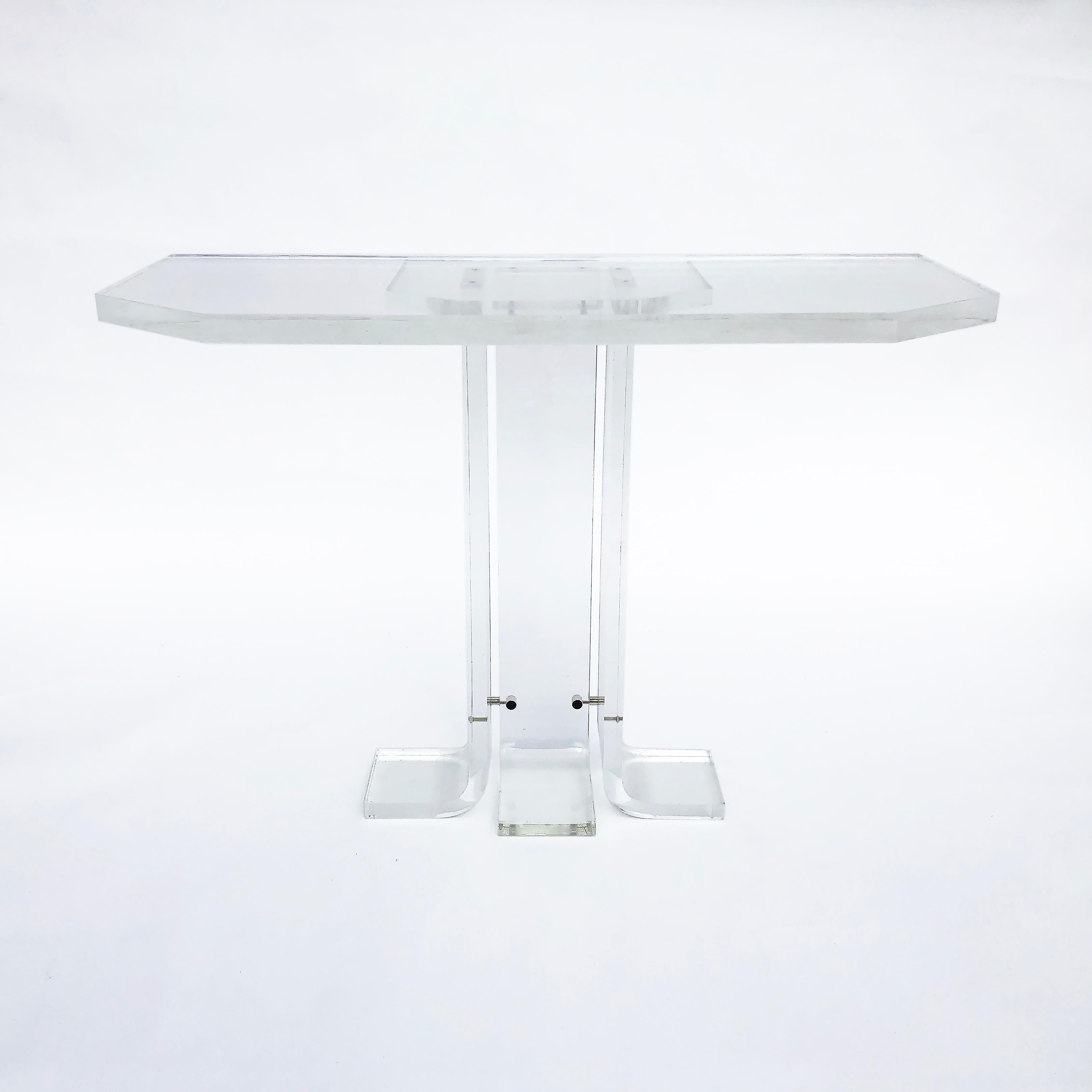 An elegant 1970s console table in the manner of Charles Hollis Jones. The hexagonal table top is supported by three curved legs, joined together with chrome fittings and another smaller top which supports the bigger table top. The table top has the