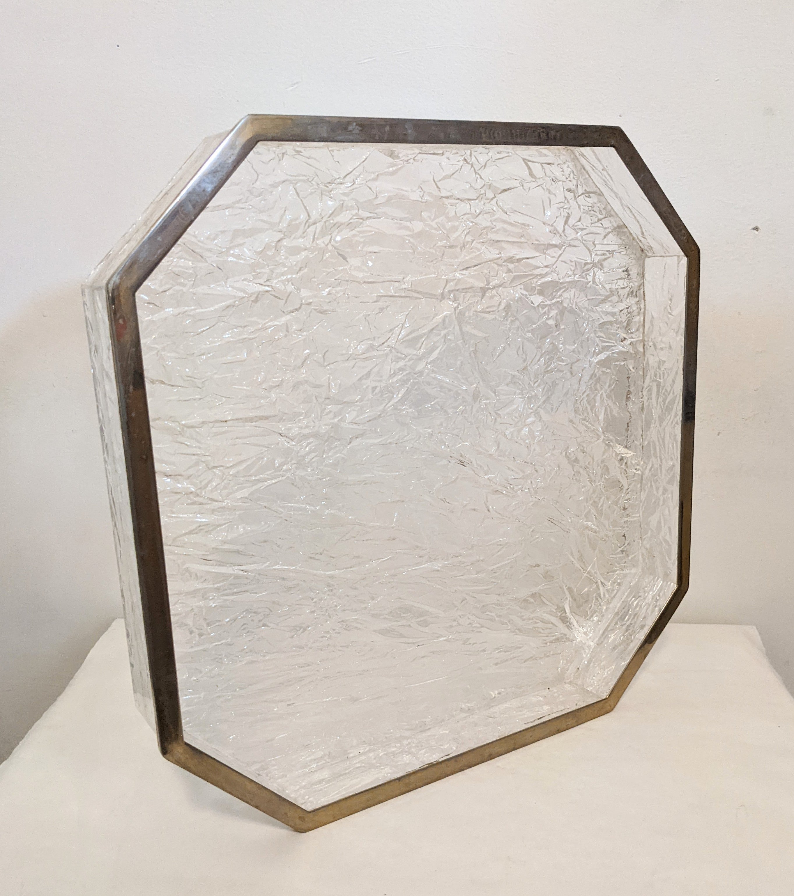 Crackle finish lucite serving tray from the 1970's with silverplated rim in the style of Willy Rizzo. Cut square corners give an interesting shape. The chipped lucite surface is placed below the tray to give an ice-y finish above, perfect for bar