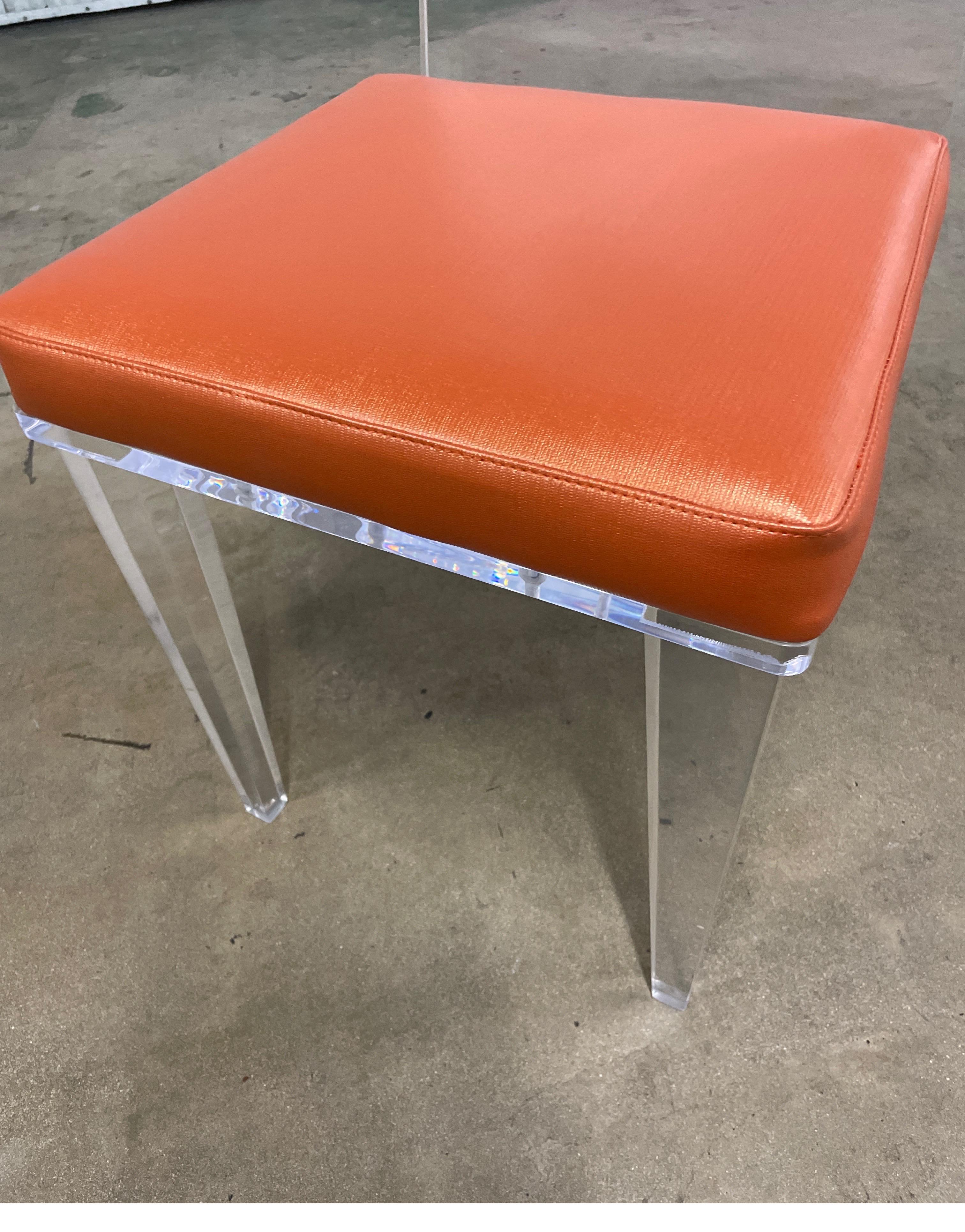 Heavy Lucite side chair with neoclassical legs and cut out back. Seat is upholstered in an Hermes orange faux leather.