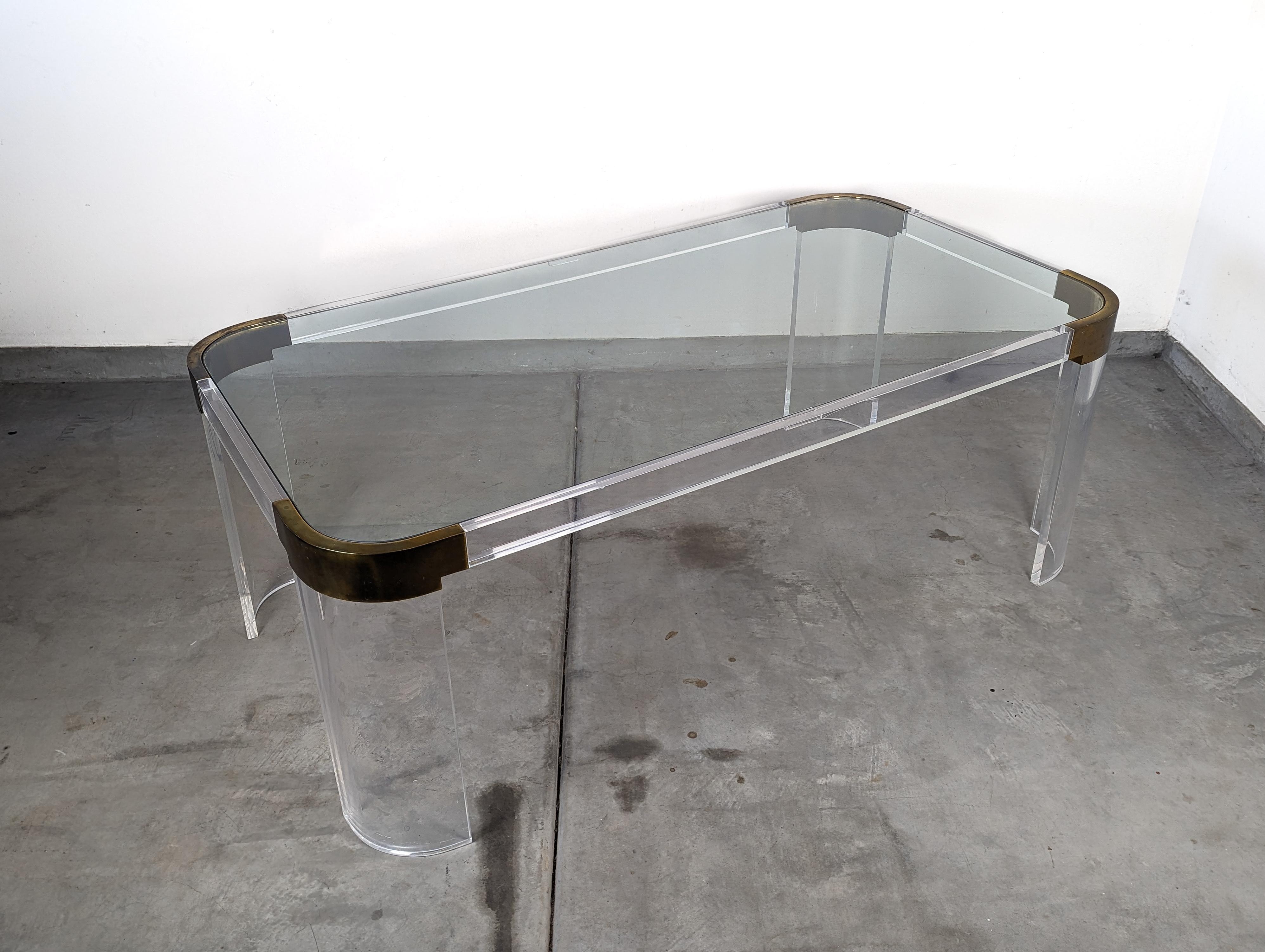 Step into the realm of vintage elegance with this exquisite 1970s Lucite dining table, a remarkable piece from the illustrious Gourmet 