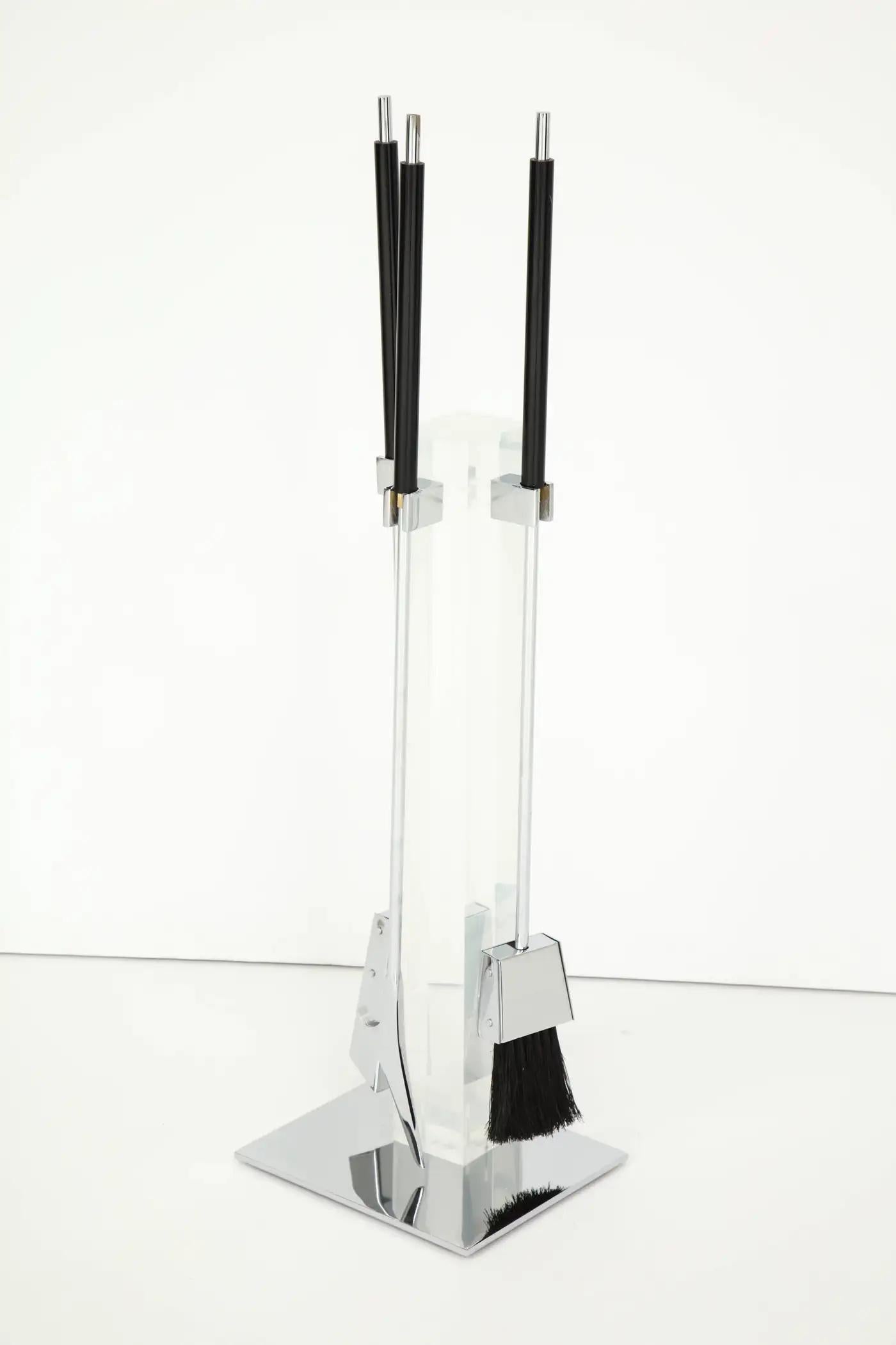 Exceptional set of chromed fireplace tools attached to a Lucite column with heat resistant resin handles.