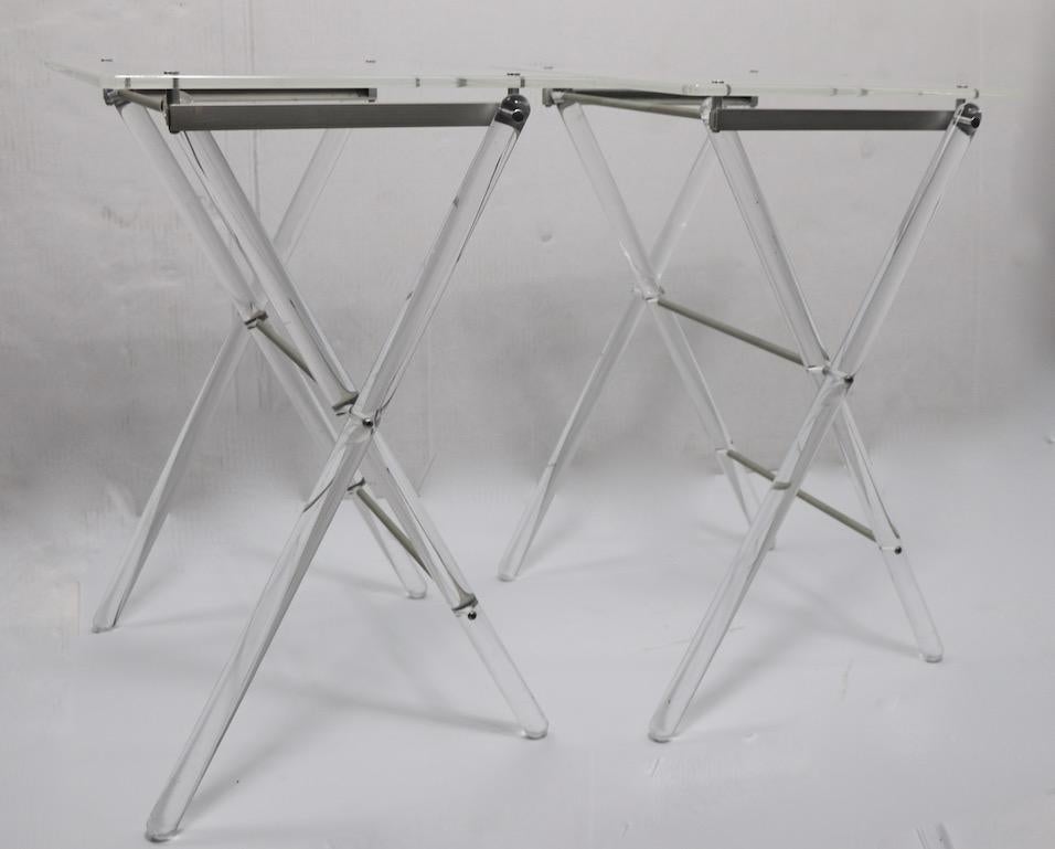 Stylish folding X base Lucite folding tables, which store on a Lucite Stand for ease of moving and storage. Tables 15 inch deep x 20 W x 24.5 inch H.