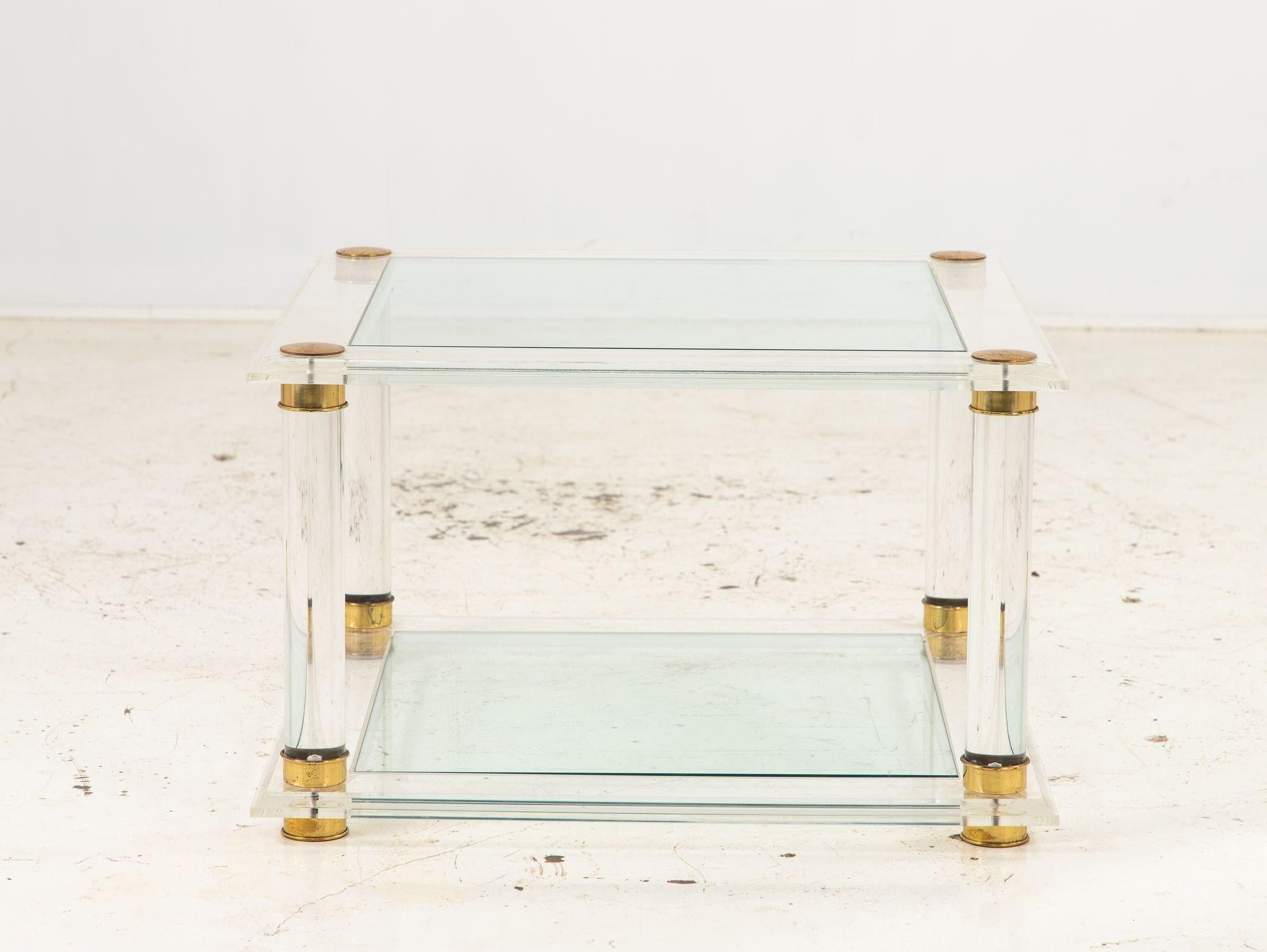 Transport yourself back to the stylish 1970s with this exquisite Romeo Paris style square cocktail table. Crafted with a fusion of materials, it boasts a transparent Lucite frame that exude an air of modernity, supporting a sleek glass top that adds