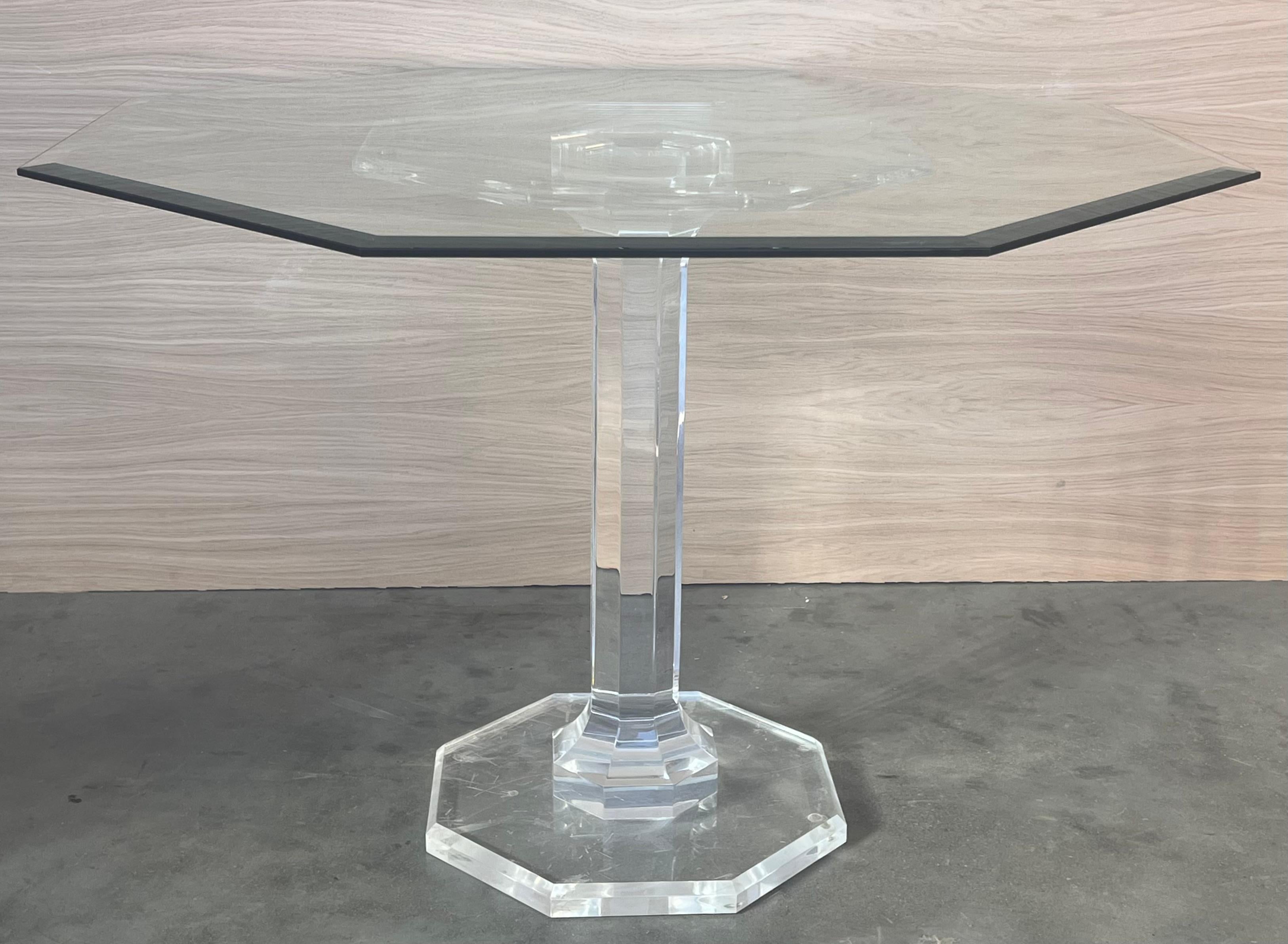 Lucite pedestal base dining table with octagonal glass top. 

