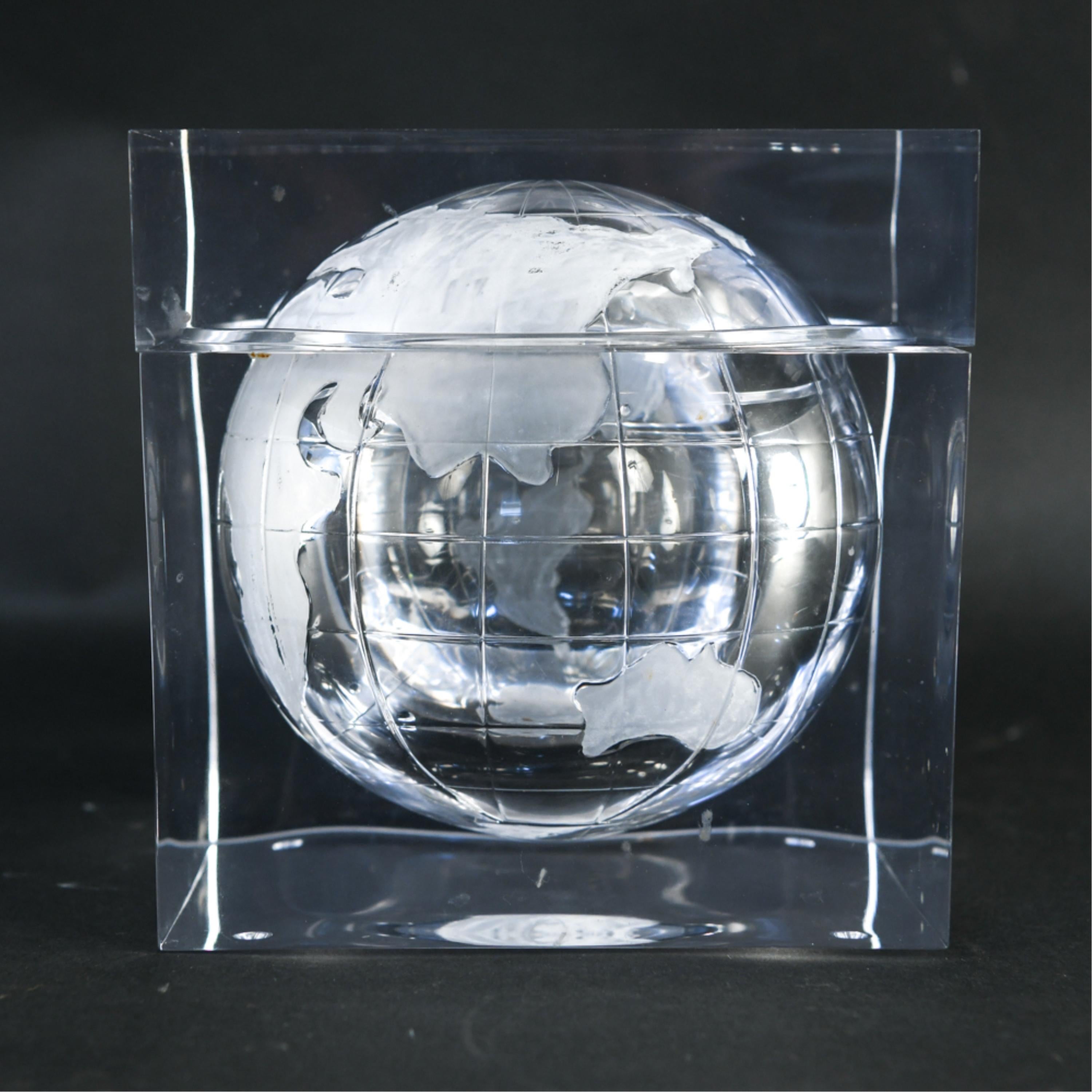 A stylish 1970s Lucite ice bucket with an internal globe form.