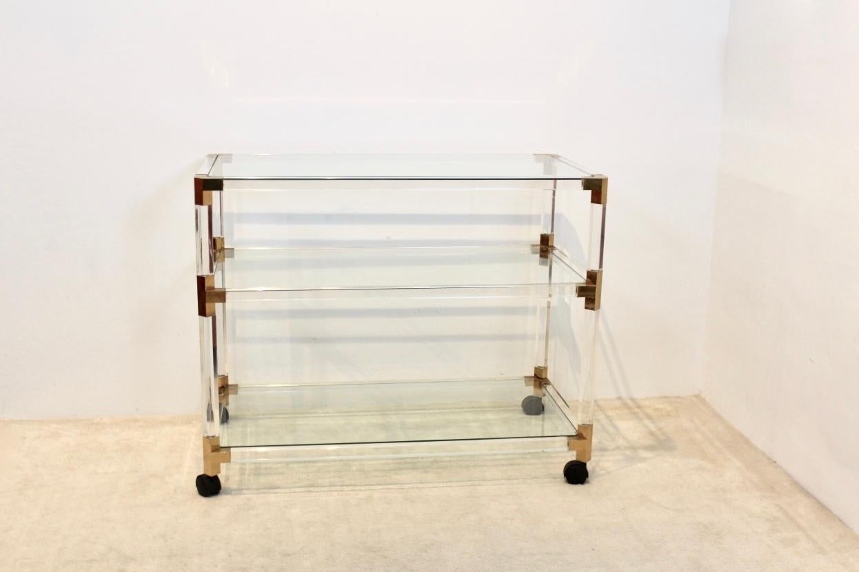 Very beautiful Paris style Lucite and gold French barcart. Frame is completely made of Lucite with beautiful Gold accents. Featuring three glass tiers. With some light wear on the gold from normal use and ageing. Typical French Paris-style of the