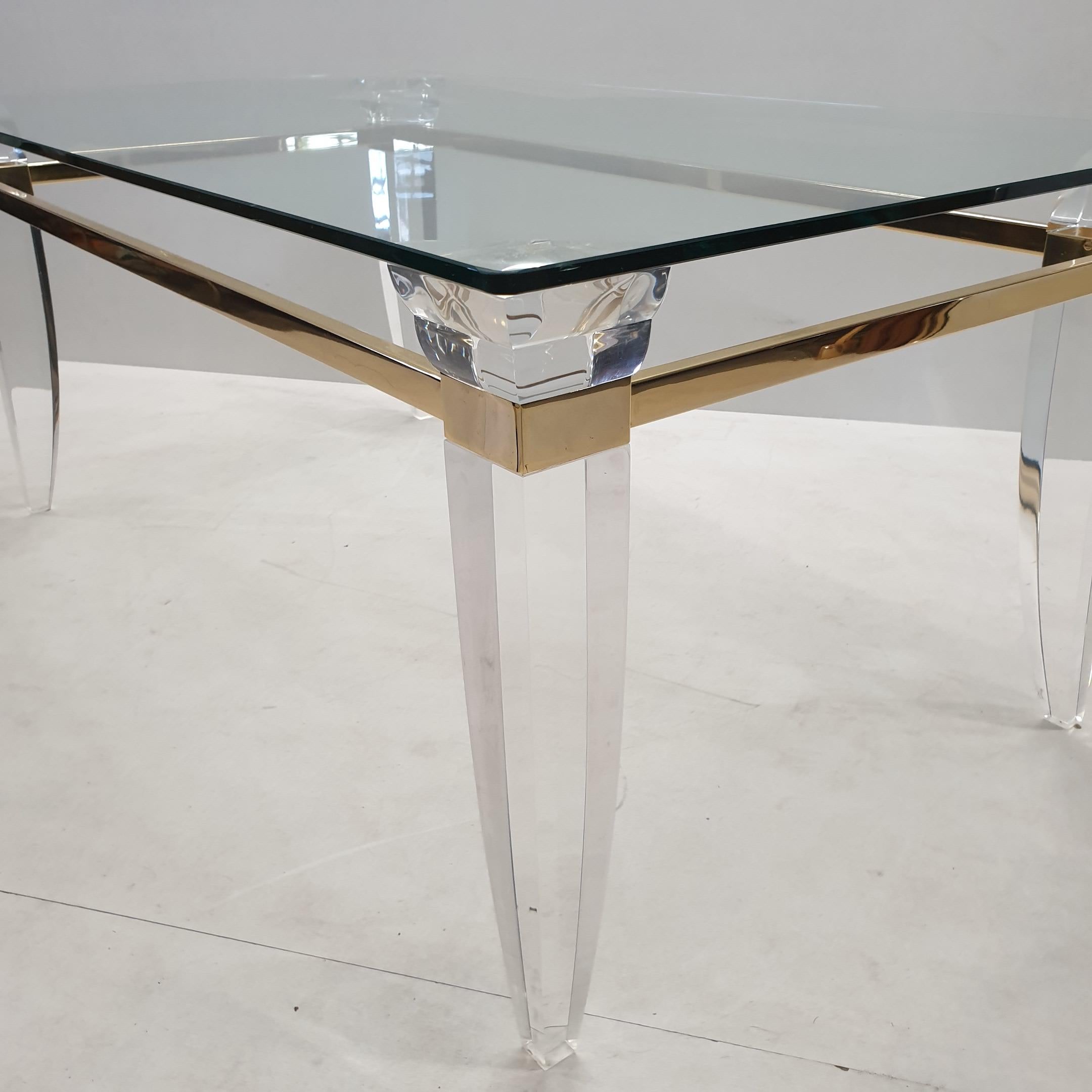 Hollywood Regency Lucite, Gold Plating and Glass Coffee Table with Assymetrical Table Legs, 1980s For Sale
