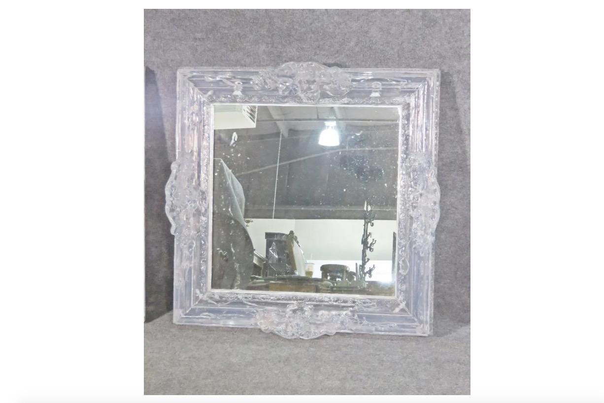 This vintage hanging wall mirror is completed by an incredible and ornate lucite frame. Please confirm item location with seller (NY/NJ).