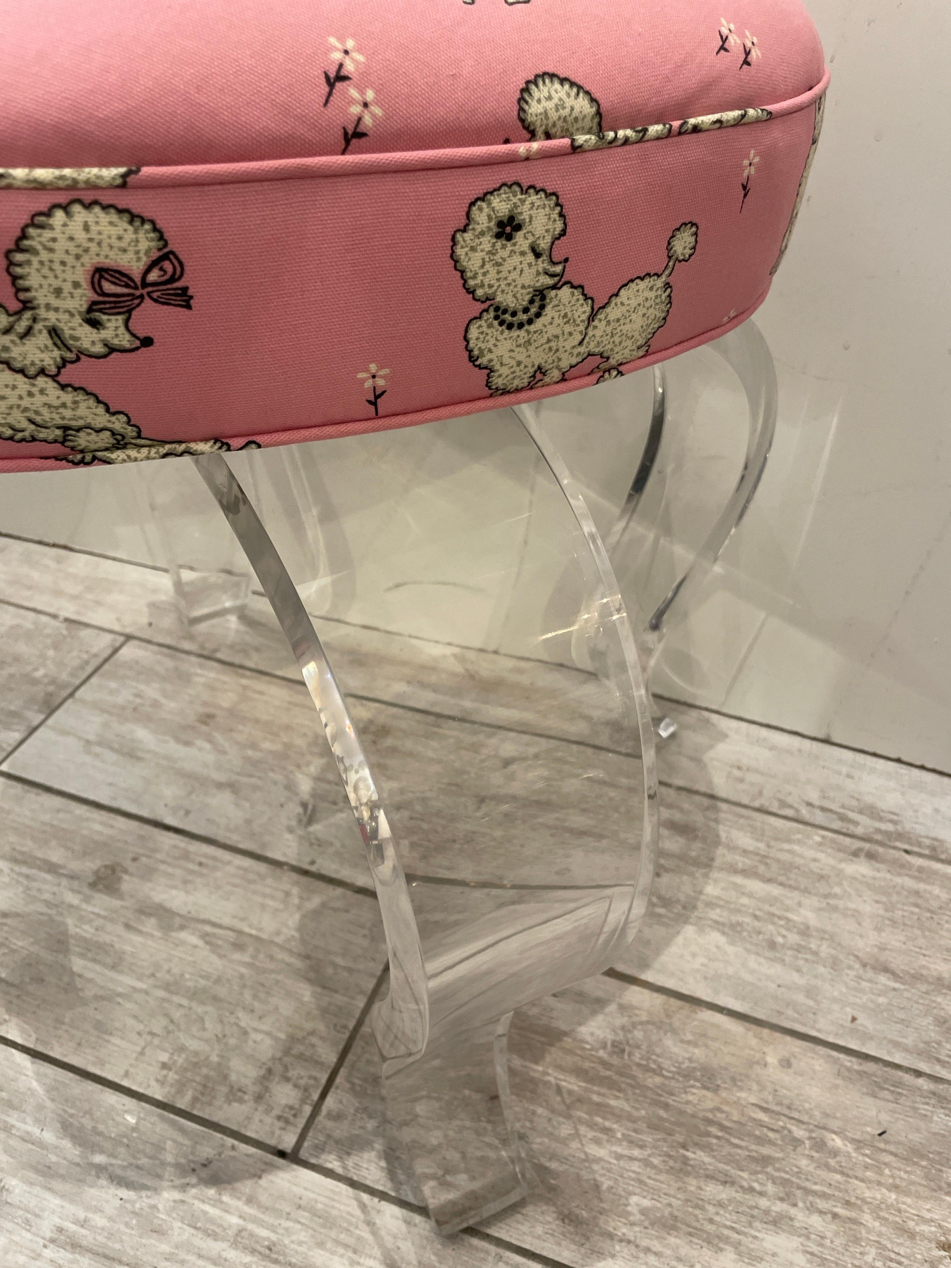 Vintage lucite swivel vanity stool with heart shaped cushion.  Newly upholstered in vintage pink and white French Poodle fabric.