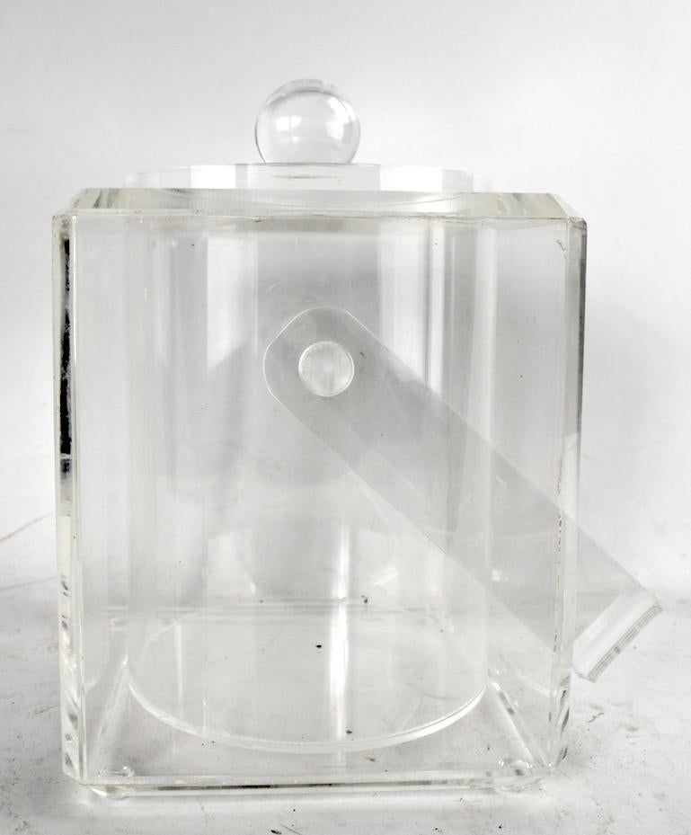 Glamorous Lucite ice bucket with swing handle and ball knob top. Clean, original condition, ready to use.
