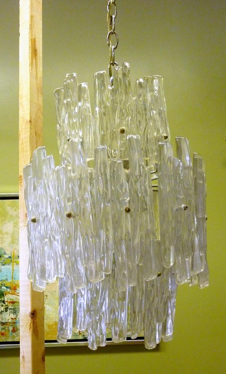 Stay cool with this eight-light chrome chandelier dripping with three tiers of Lucite icicles by EMR Lighting.

Kalmar made a similar fixture with glass instead of Lucite.

Height measurement does not include the chain.

We have an extensive