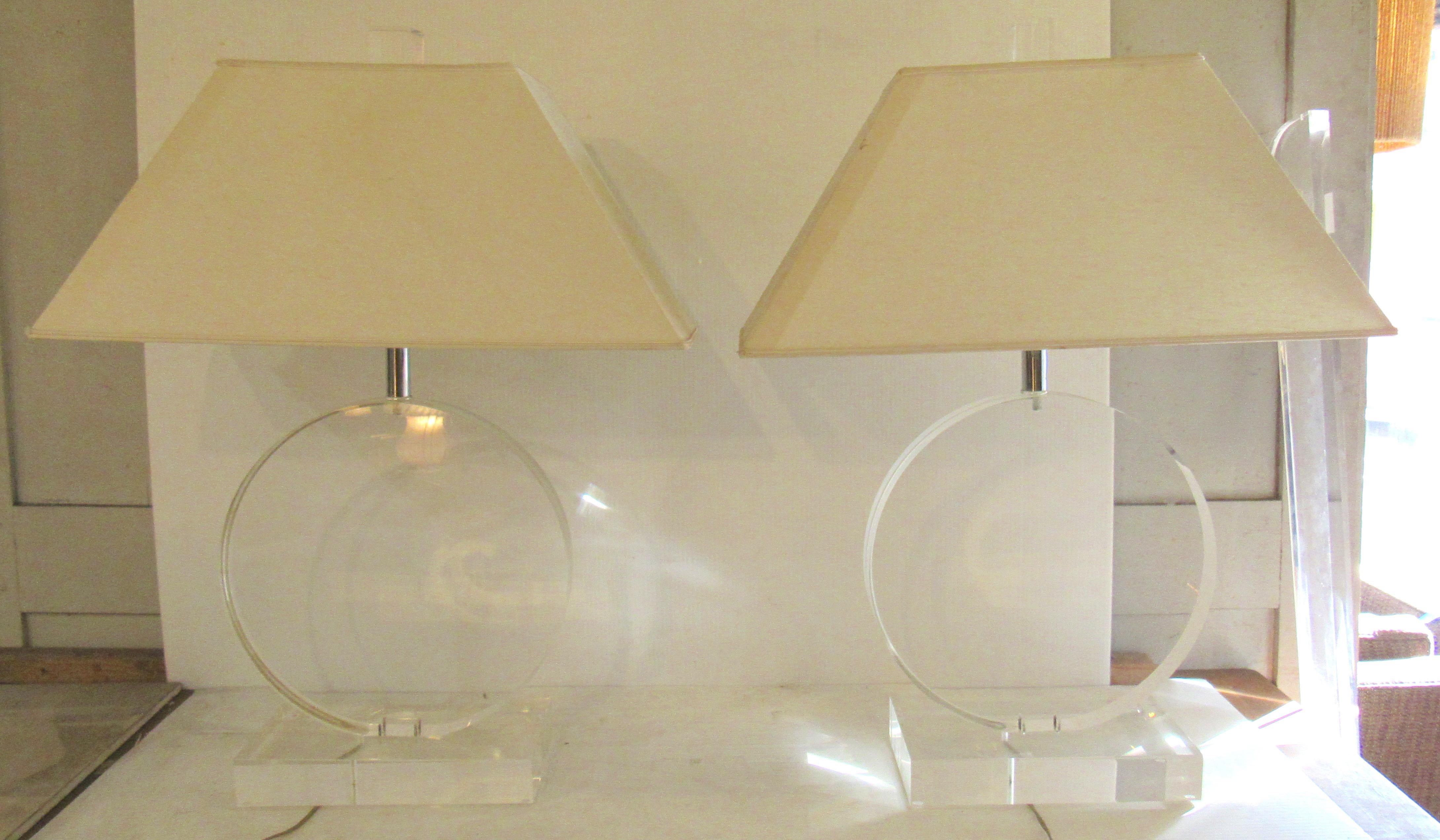 Pair of Mid-Century Modern table lamps made of thick clear Lucite. Wire is hidden on the side of the round base.
Lamp: 14