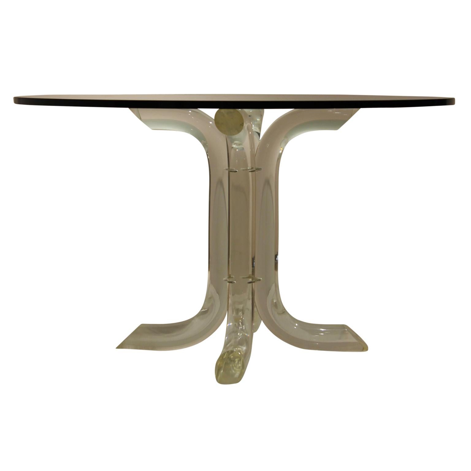 Mid-Century Modern dining table with the original Lucite base from the 1970s and a glass top. The table is in the style of famous Lucite furniture designer Charles Hollis Jones. Towards the bottom of the leg is come crazing but it is not significant