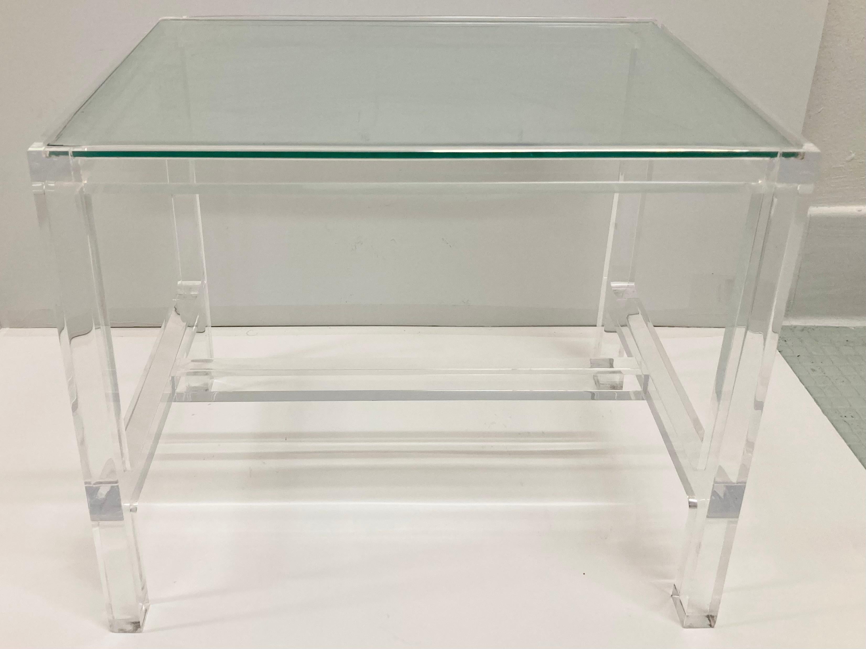 Modern lucite cocktail or side table with beautiful detail work on the frame and lower lucite stretchers. Inset glass top adds to the modern design. Fun fact: the estate of a Hollywood legend.