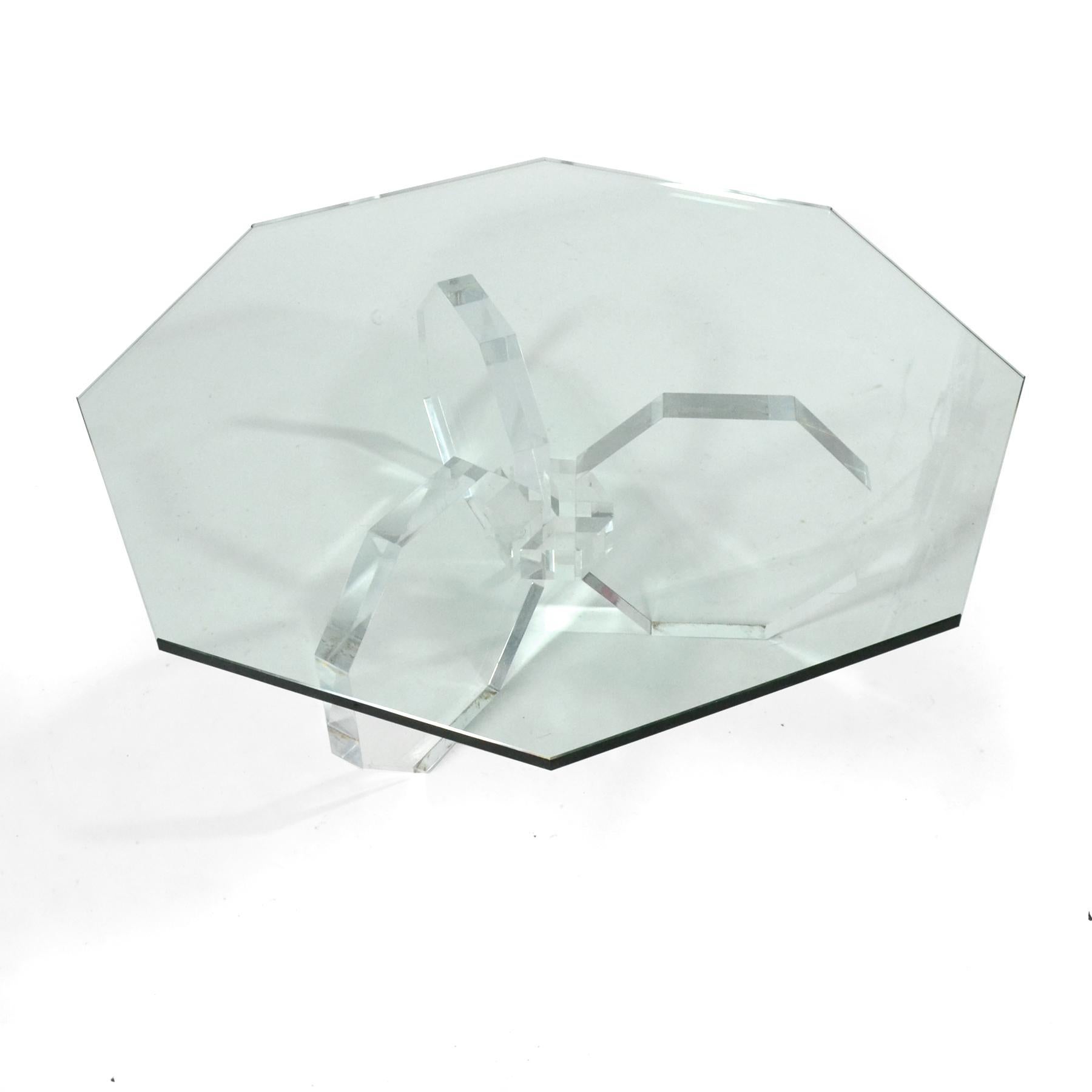 This striking coffee table has an acrylic three-legged base that echoes the octagonal shape of the glass top.