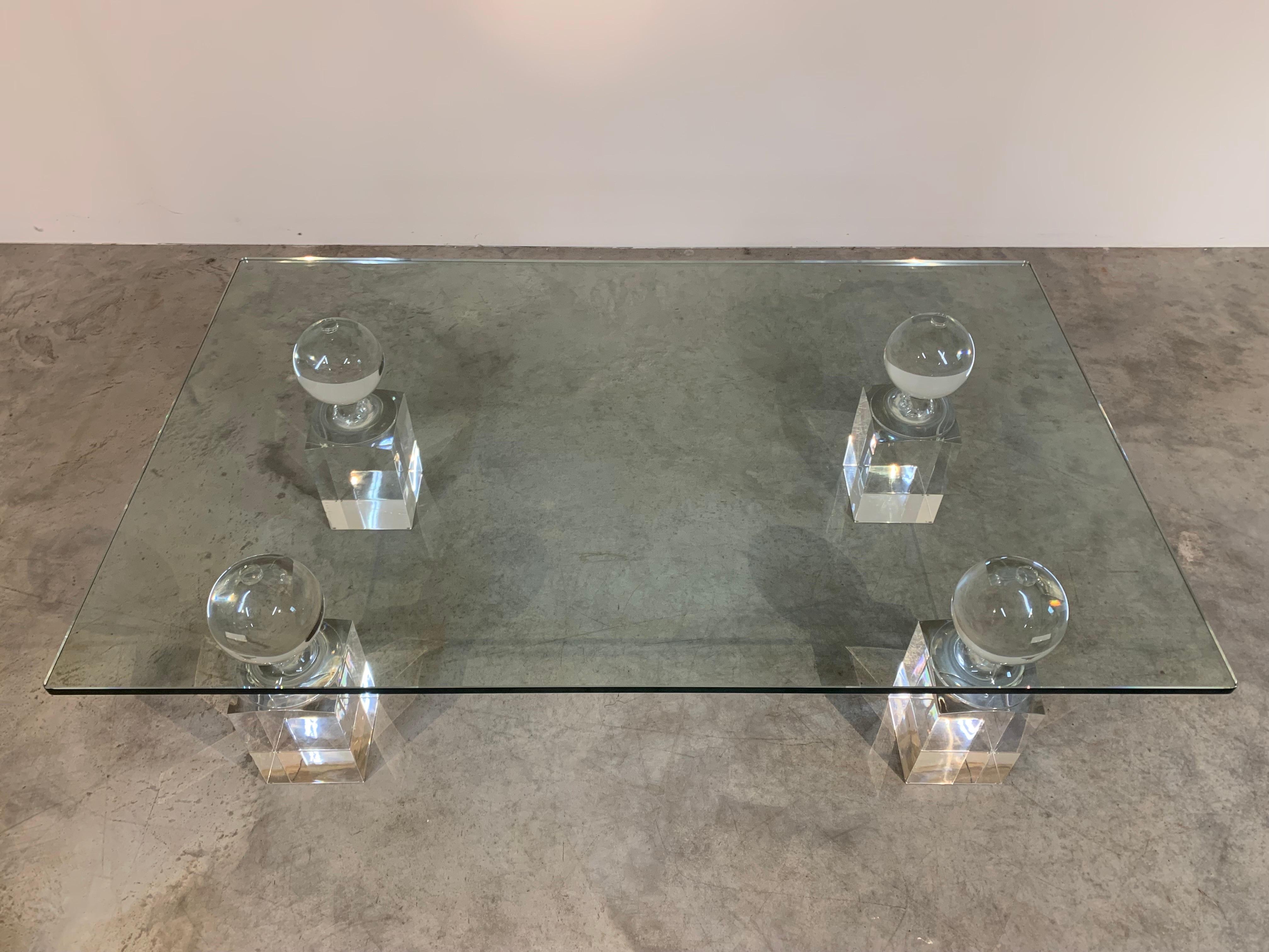 Tempered glass coffee or cocktail table over monumental pawn shaped lucite pillar stands. 
 A rare and striking table attributed to Charles Hollis Jones circa 1980. 
 Each pillar measures 16” High x 5.5” Wide & Deep. 
Tempered glass is 1/2” thick