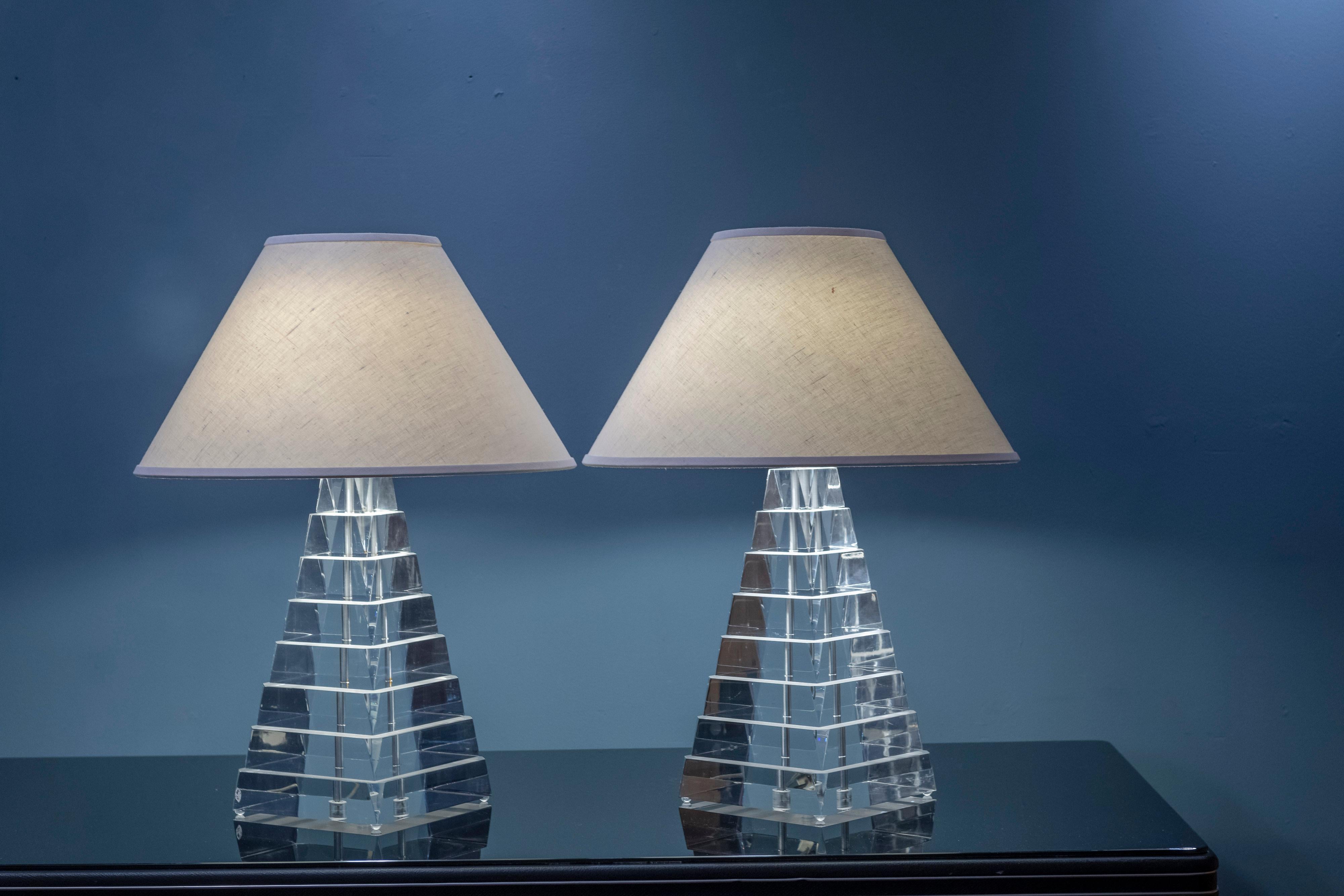 Pair of stacked pyramid form table lamps attributed to George Bullio. High quality construction and materials these would be focal points for any interior. Everything works as it should with two sockets per lamp and original shades in good condition.