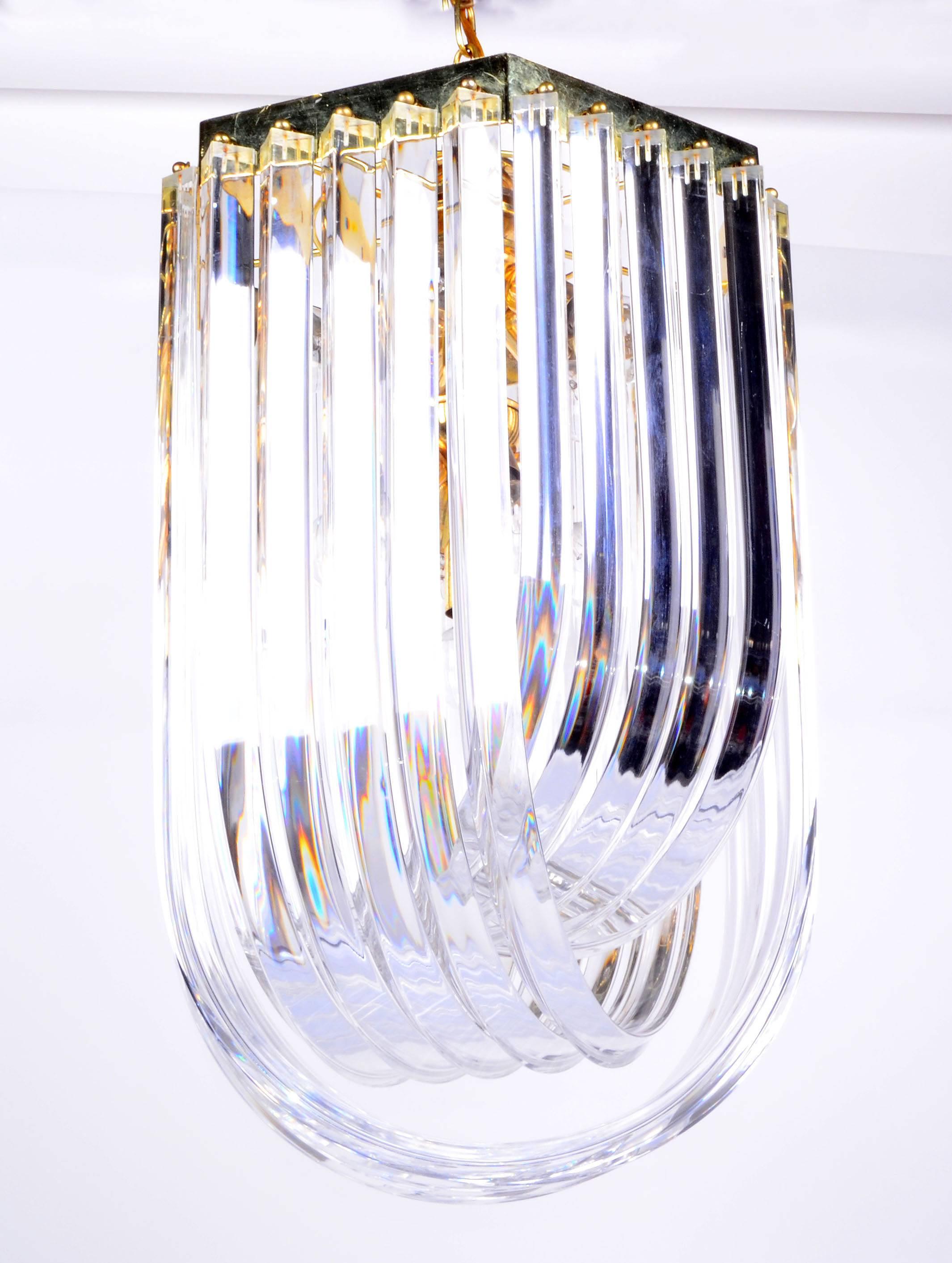 A large, Mid-Century Modern Lucite ribbon chandelier with canopy.
Wired for the U.S. and in excellent working condition, uses ten-light bulbs max. 25 watts each.
Length of chain: 26 inches.