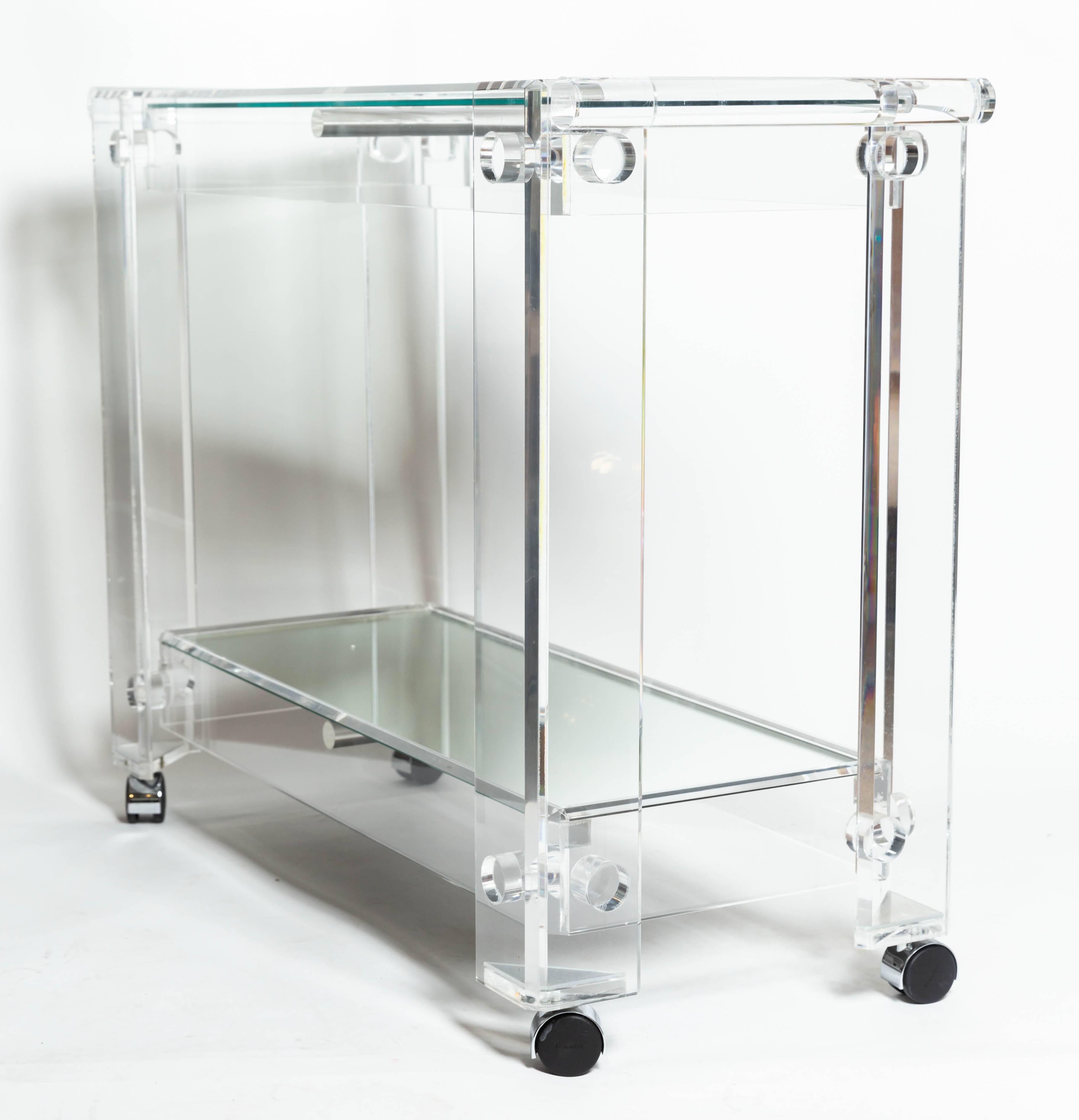 Lucite rolling cart featuring two mirrored shelves.