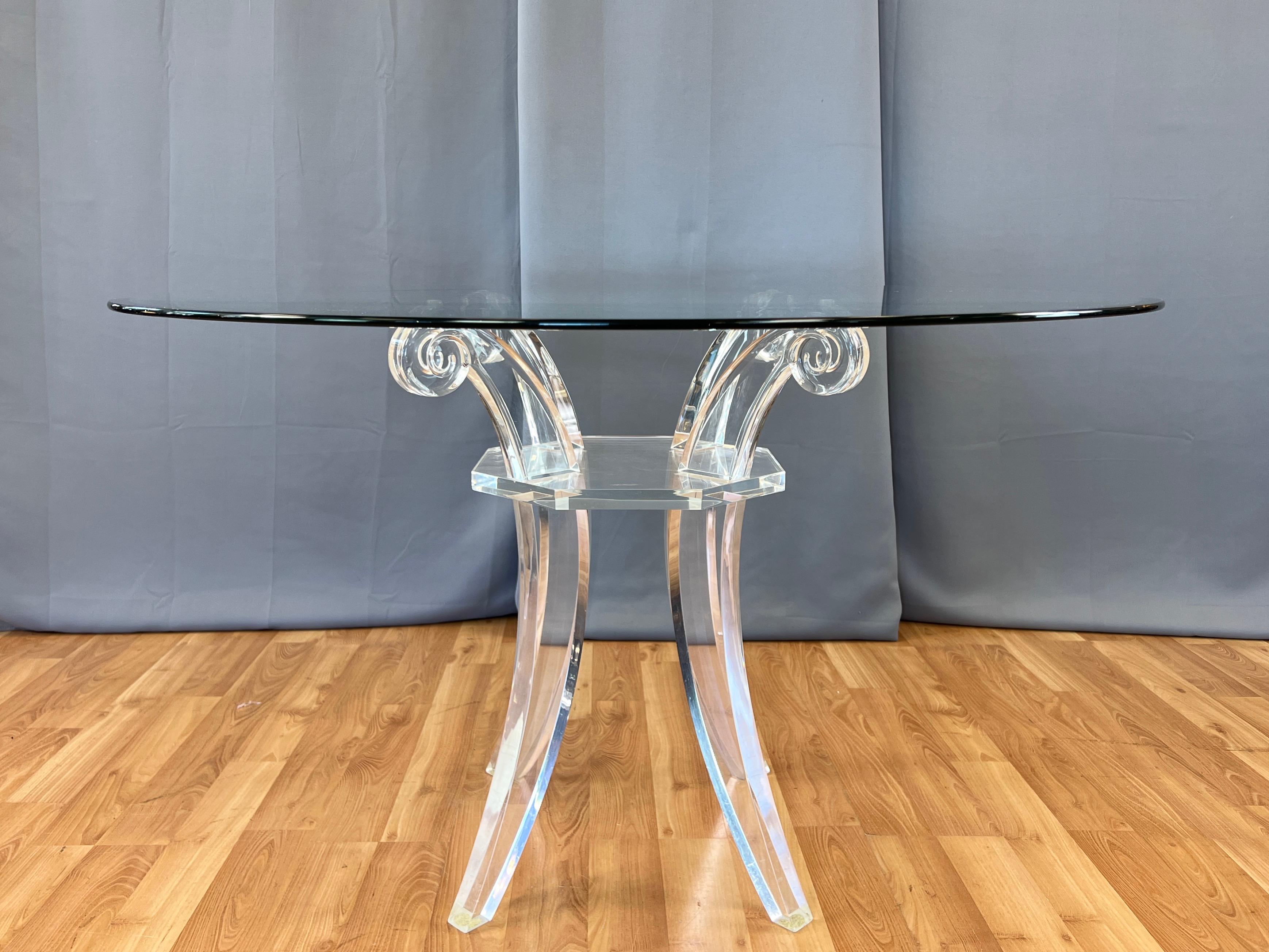 A glamorous and uncommon circa 1980 Charles Hollis Jones-style saber leg lucite dining table with large round glass top.

Base comprised of crystal clear and thick solid lucite elements that display very high quality material and craftsmanship.