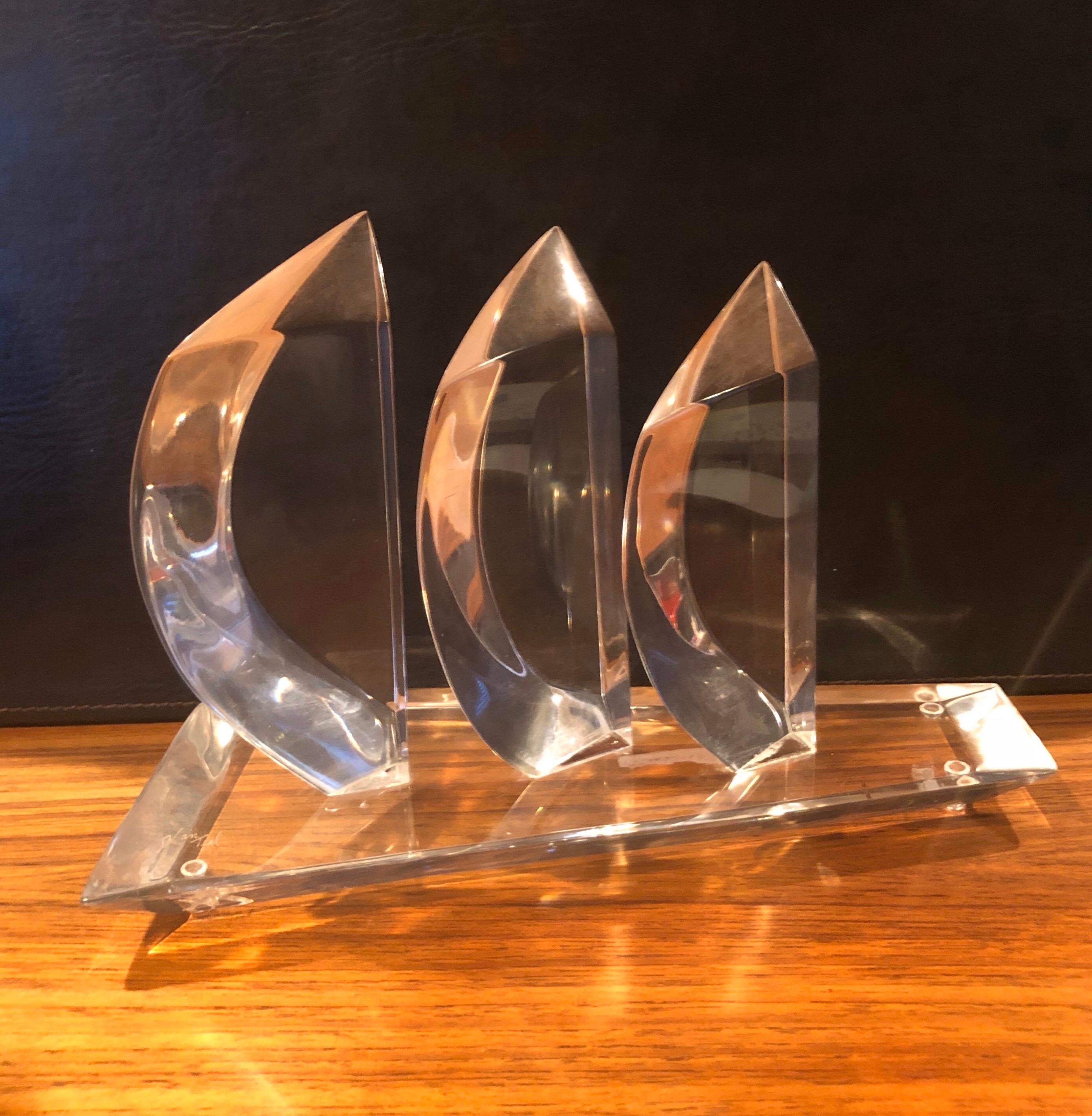 Lucite sailboat sculpture by Hivo Van Teal, circa 1960s. This beautiful sculpture of three sailboats in the wind is in great condition with no chips, cracks or crazing. There is a small hazy spot between two of the sails that is in the Lucite,