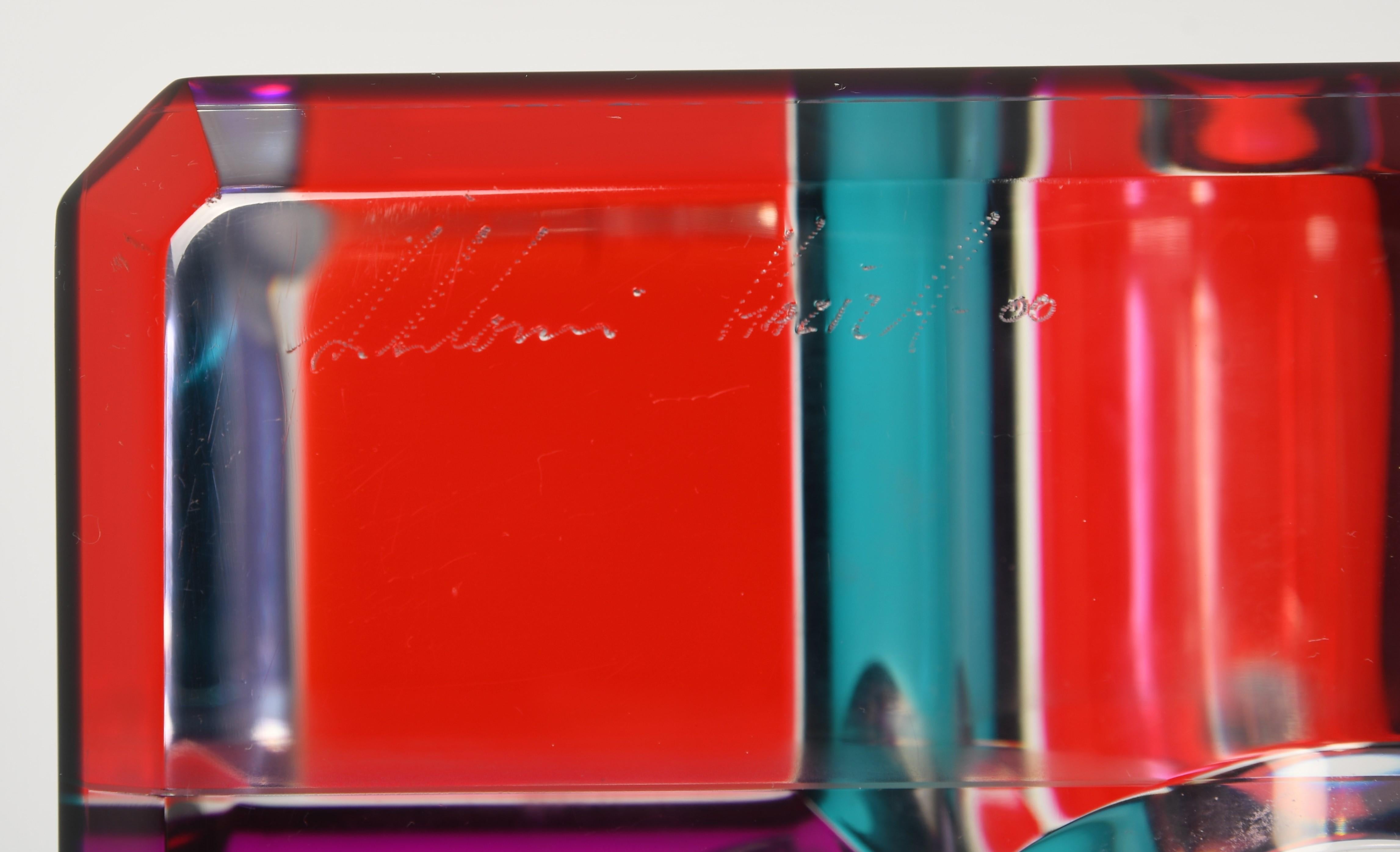A stunning Pop Art Lucite sculpture by Shlomi Haziza. The cube sculpture is comprised of colored Lucite which refracts light on top of the black pedestal base. Signed Shlomi Haziza, as shown in images. Some minor scratches to the surface but not