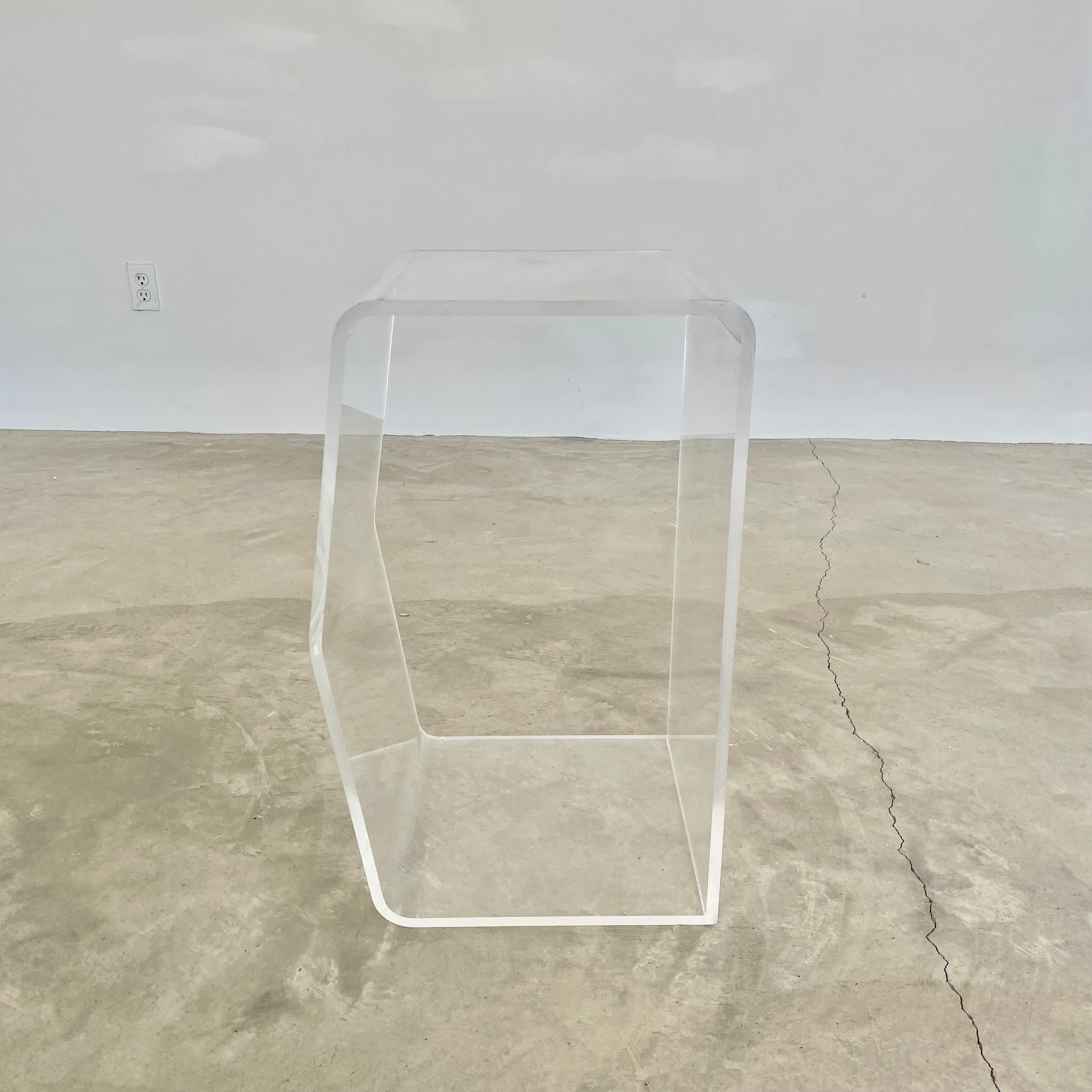 Rectangular shaped lucite side table with one wall protruding out into a gable. Made circa 1980. A gorgeous, subtle and modern accent piece that would work seamlessly in any room as side table, drink table or even as a nightstand. Good condition to