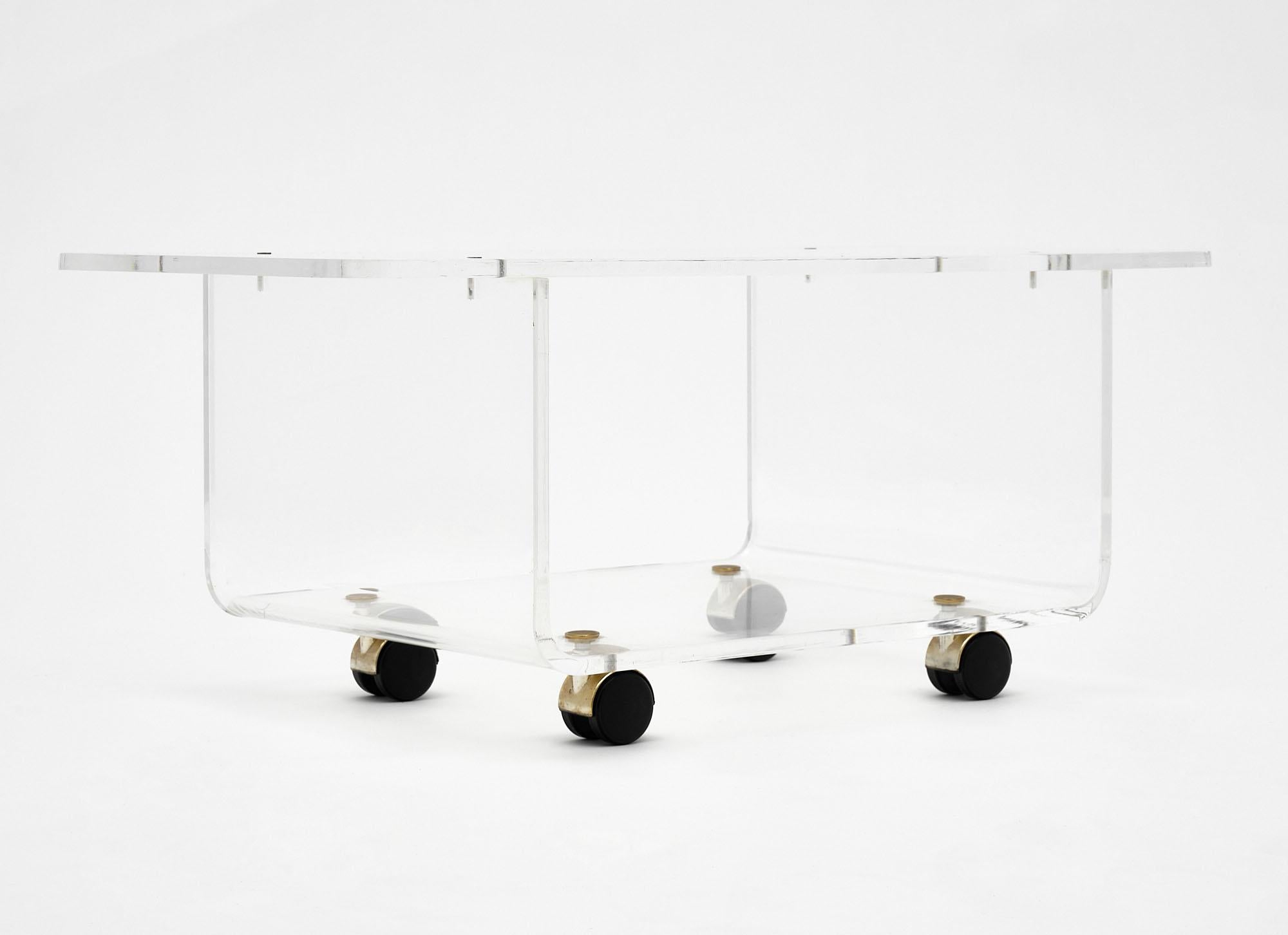 Side table made of Lucite on casters. This French piece is by David Lange.