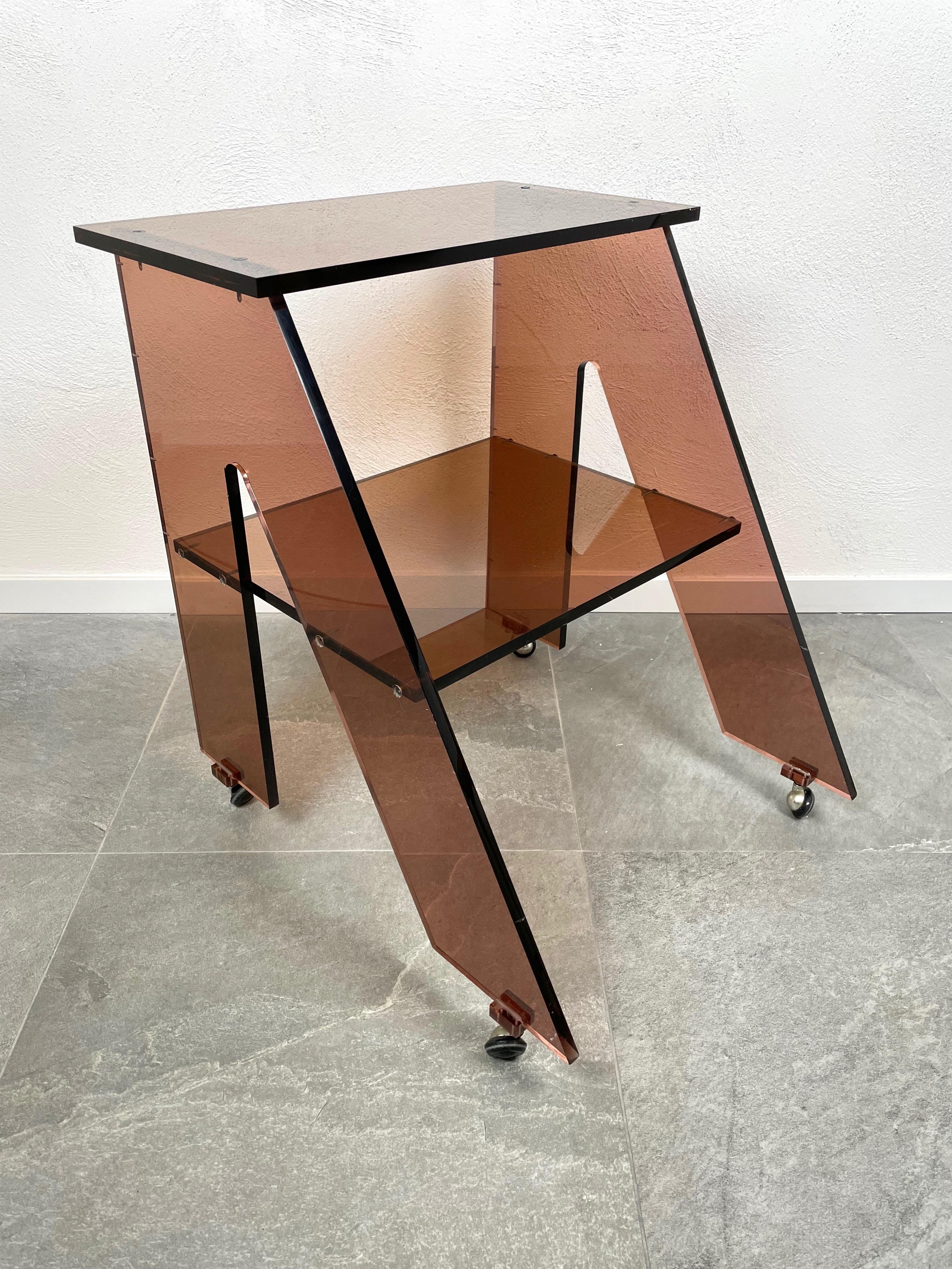Side table cart in smoked Lucite designed by Michel Dumas for Roche Bobois. Made in France in the 1970s.