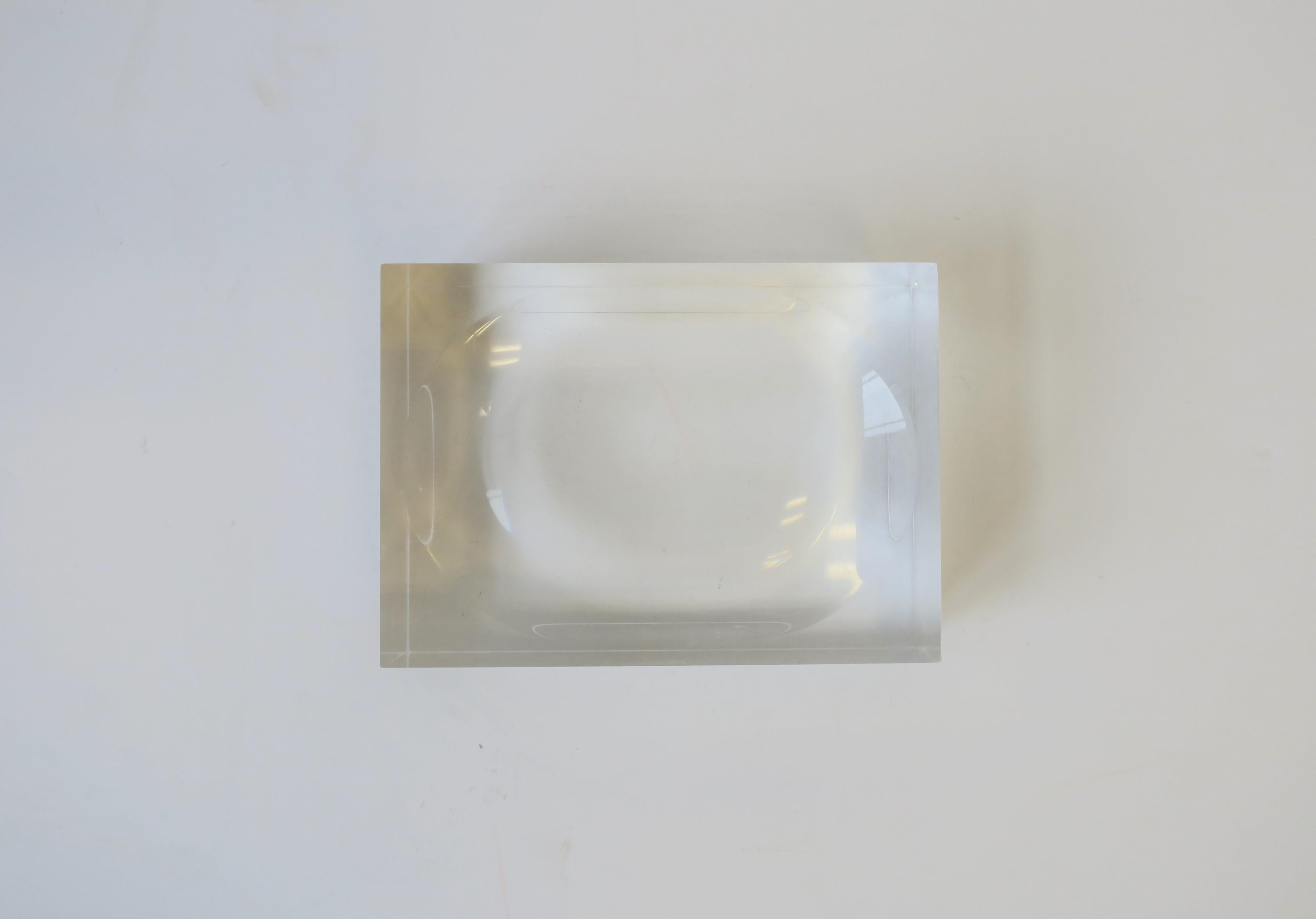 A thick Lucite soap dish; fits a standard size bar of soap or smaller.