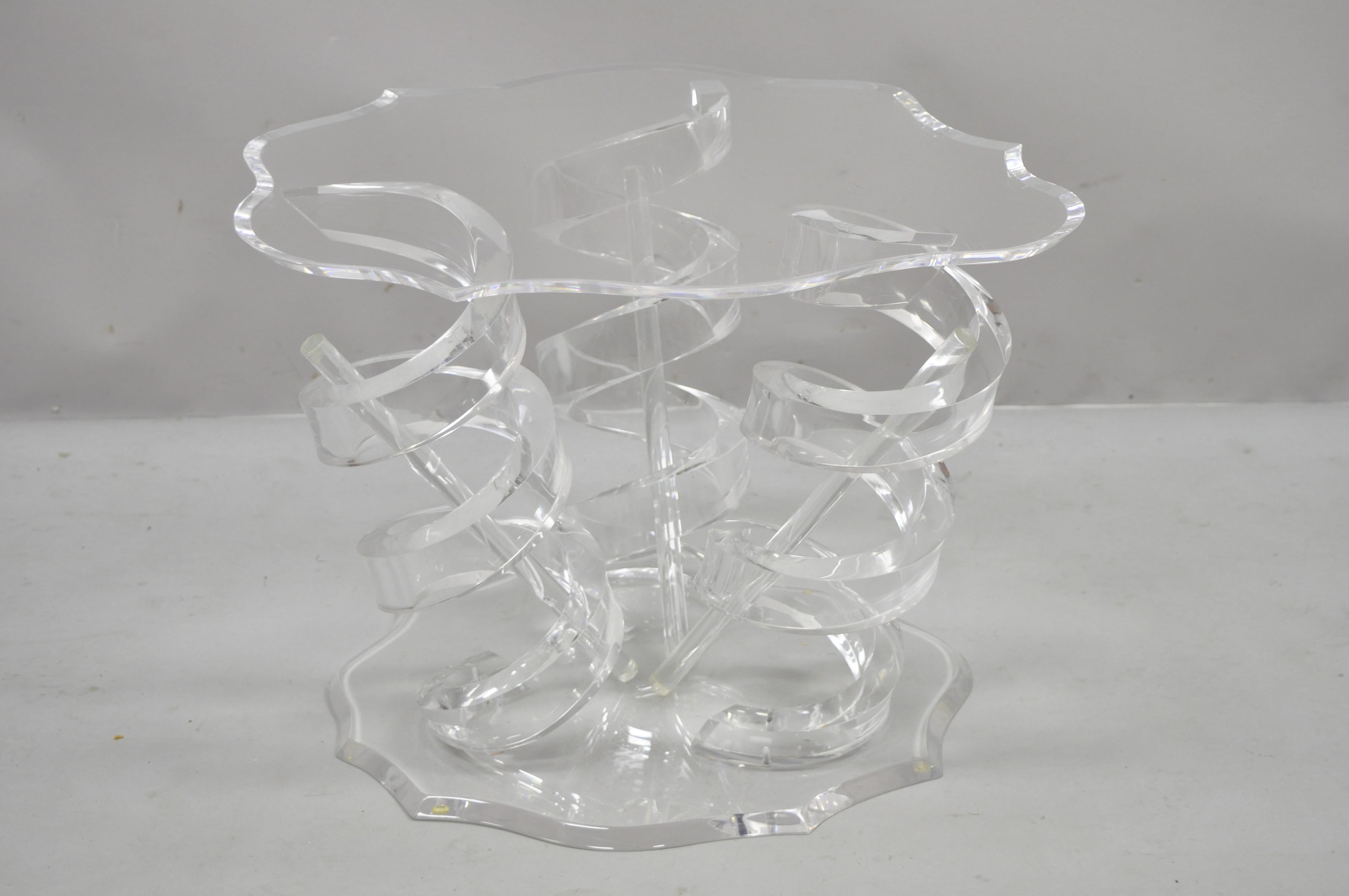 Lucite spiral coil spring base Mid-Century Modern coffee table. Item features shapely lucite top, spiral coil springs, triple pedestal base, lucite rod 