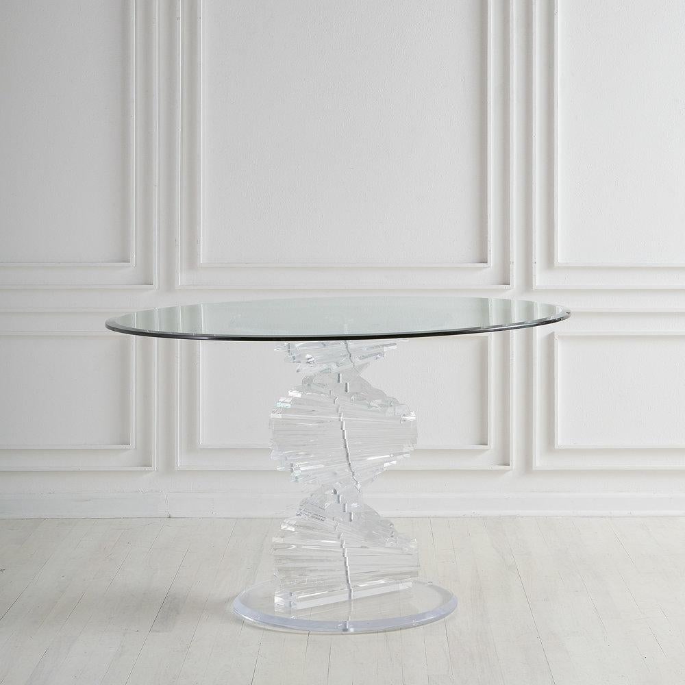A beautiful dining, eating or entryway table featuring a helix shaped base formed of solid lucite and completed with a 48” glass top. A statement piece that brings drama while allowing other things in the room to be seen and admired!