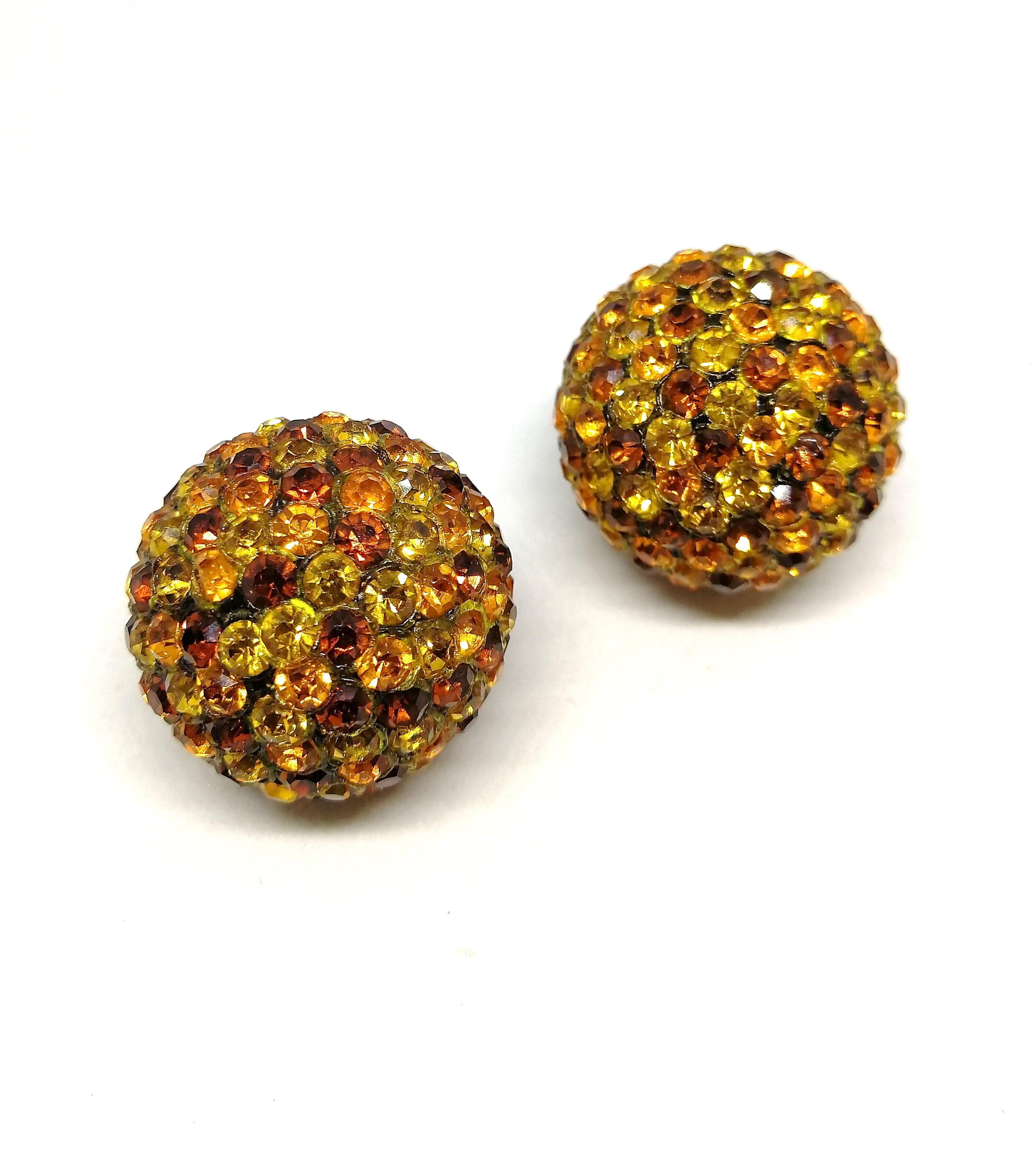 These wonderful sphere earrings are fun to wear, light and easy. Made from clear lucite balls, they are studded with various shades of paste, topaz, orange and yellow, with a nice firm clip. Maker and country of origin unknown, and from the 1960s,