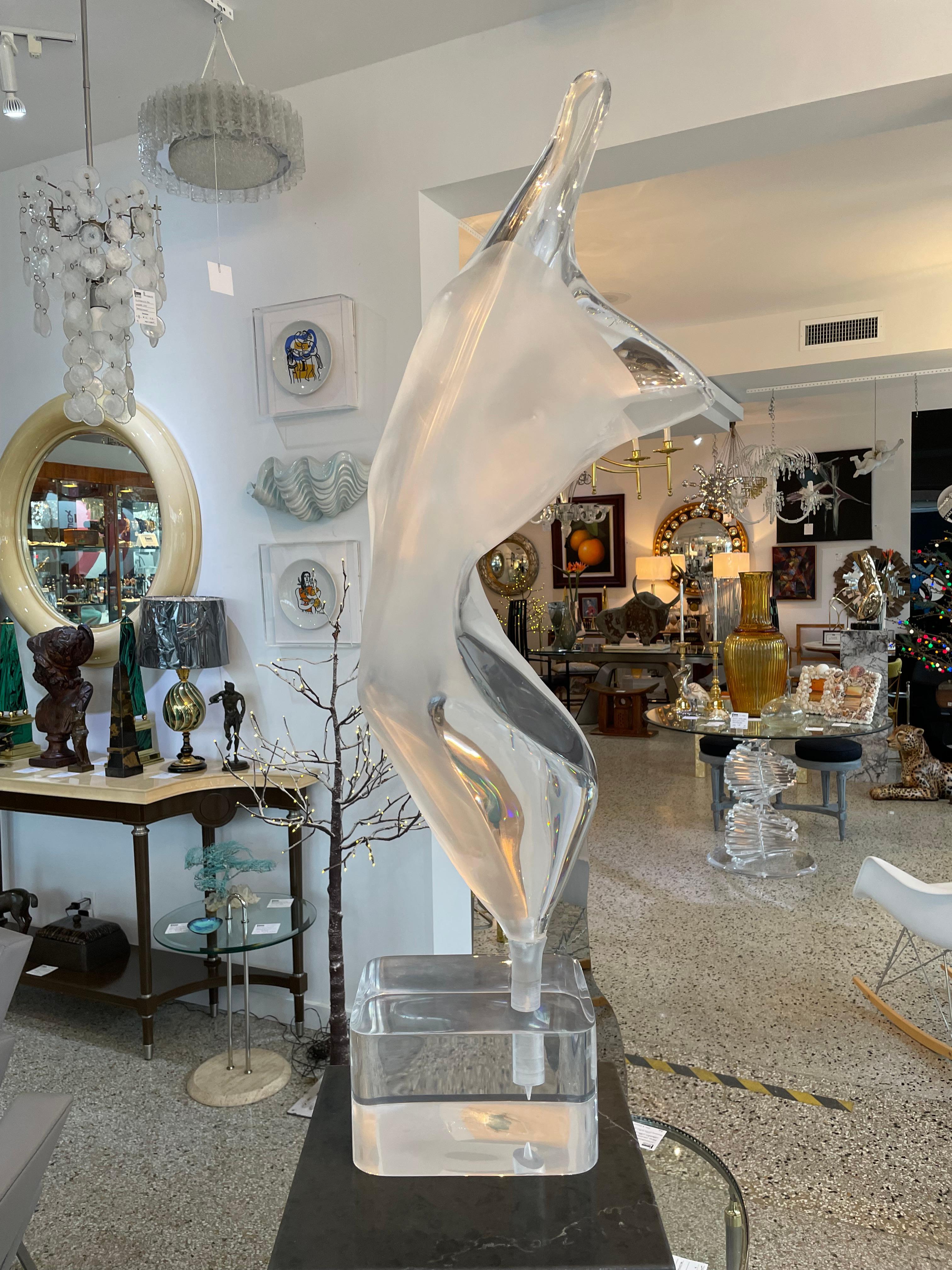 This large scale lucite sculpture depicts an abstract nude female form in an elongated pose, and is by the sculptor Michael Shacham. 

Note: The piece is fabricated in clear and satin finished lucite. 

Note: Signed on top of base Acrylicia Ltd.